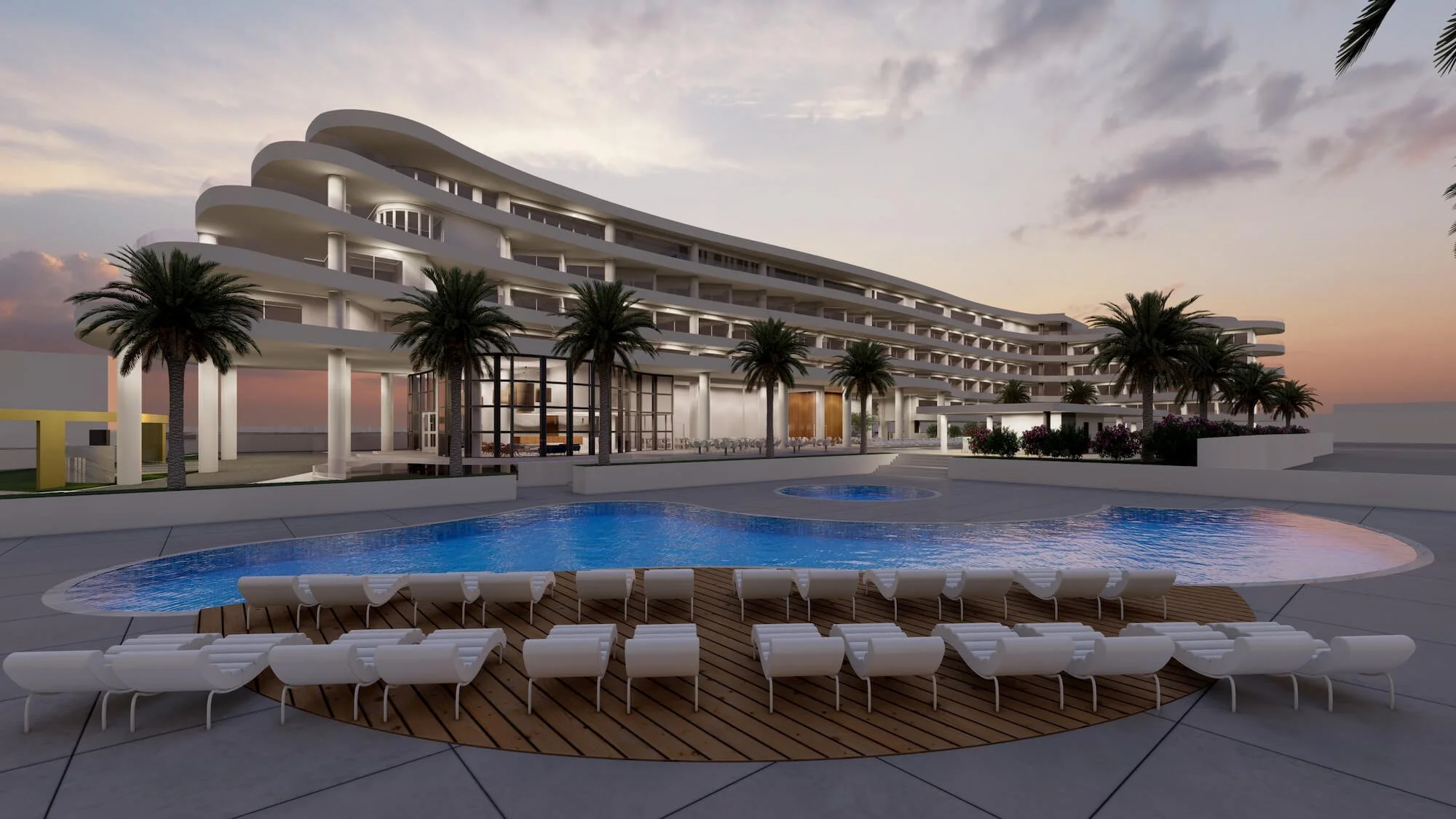Modern hotel with pool and palm trees at sunset