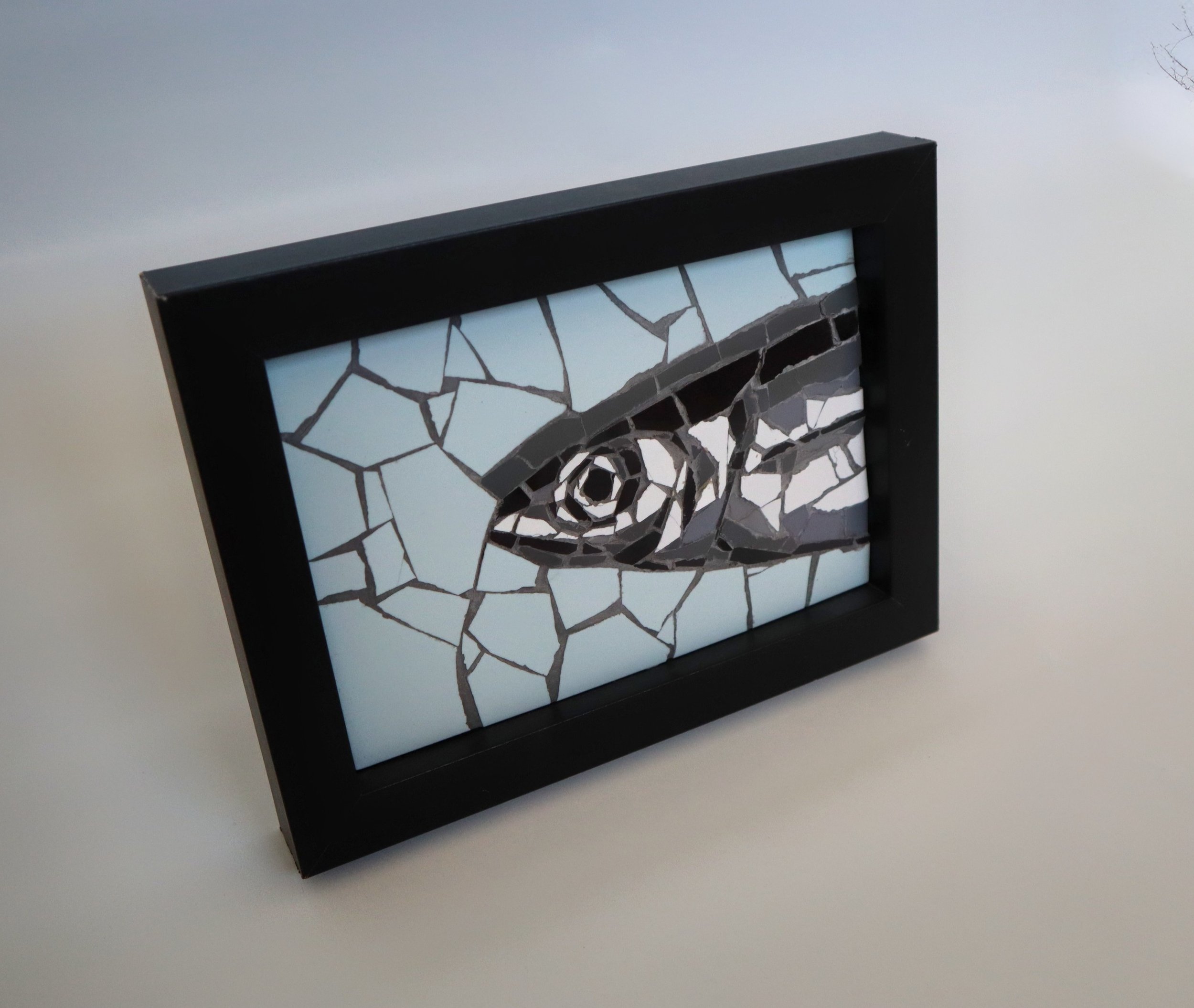 Handmade mosaic tile artwork of a sardine in greys and pale blue, framed in wood – one-of-a-kind original