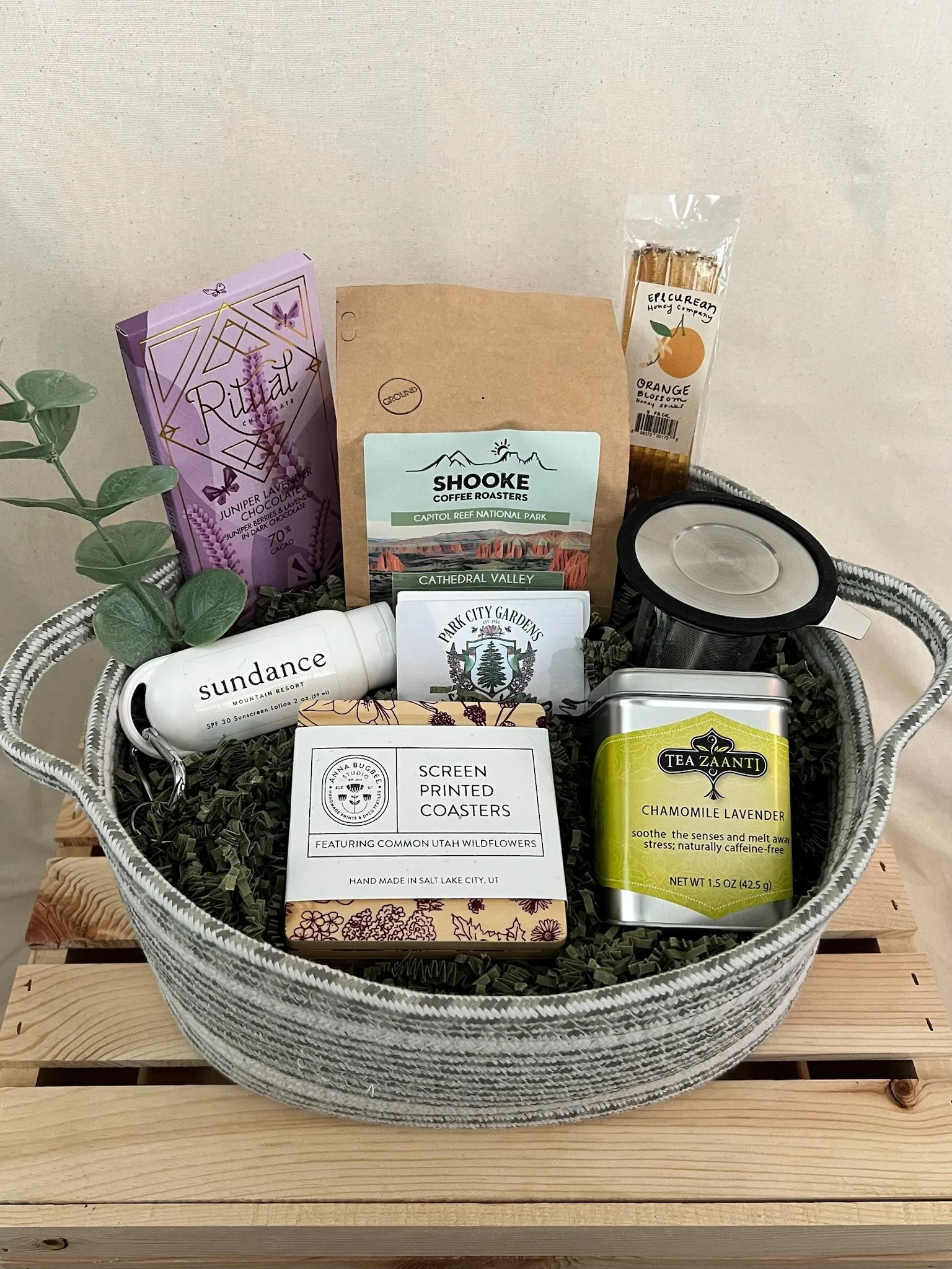 Utah botanicals gift basket with coffee, tea, chocolate, honey, wildflower coasters, and Sundance sunscreen