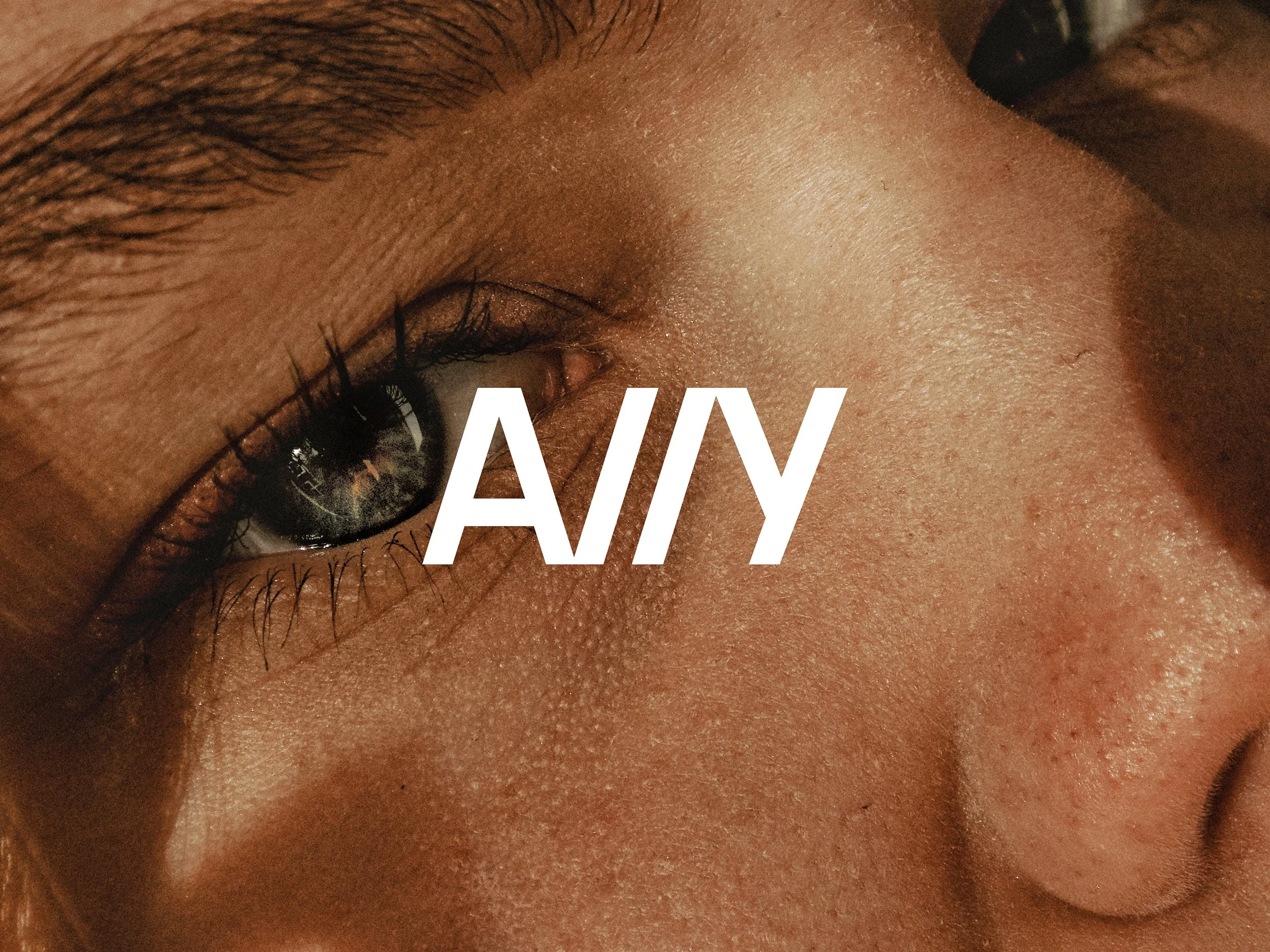 Close-up of a person's eye and nose, with the word 'ANY' overlayed in the center.
