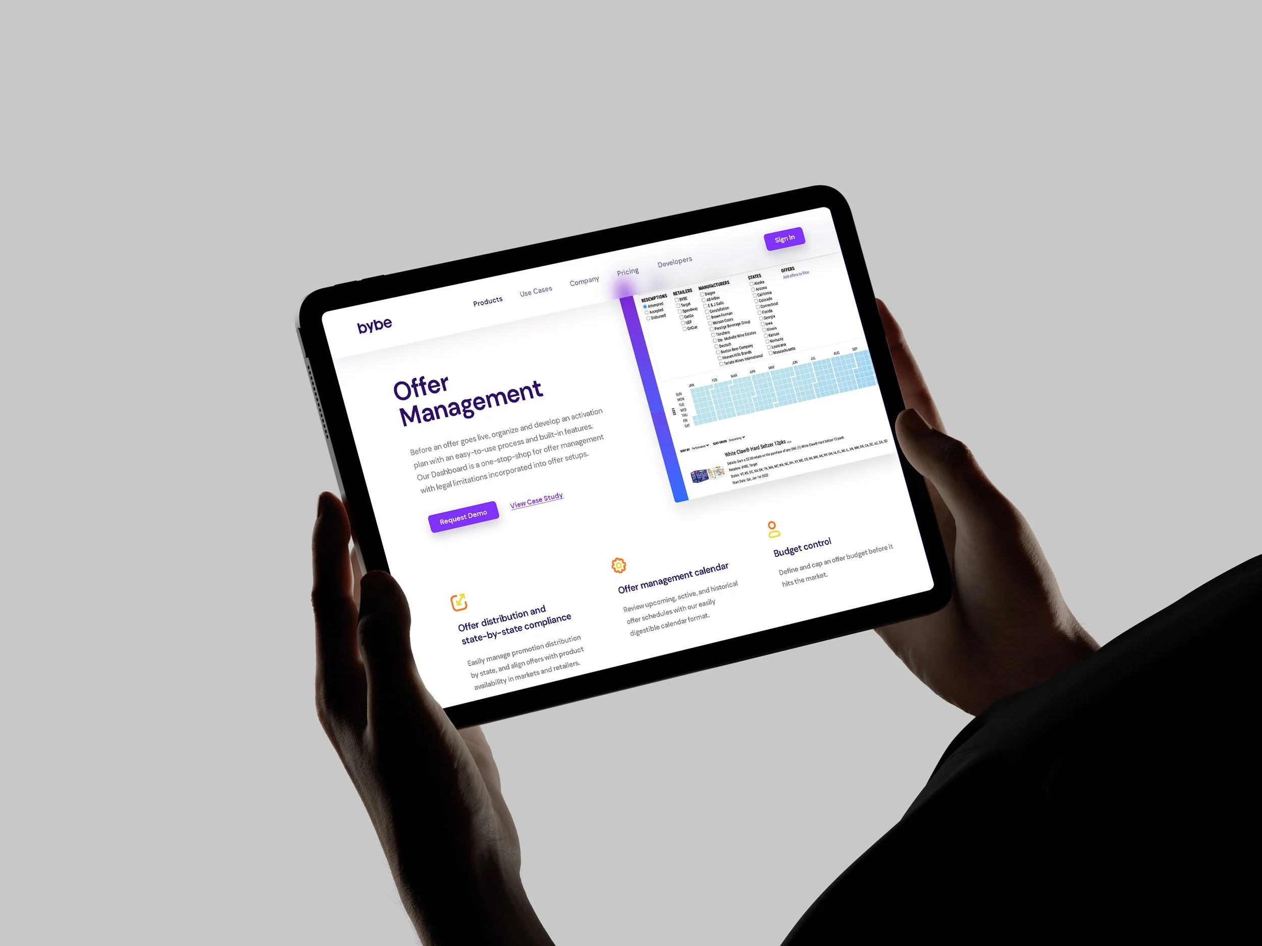 Person holding a tablet displaying a webpage for offer management with text, icons, and data charts.