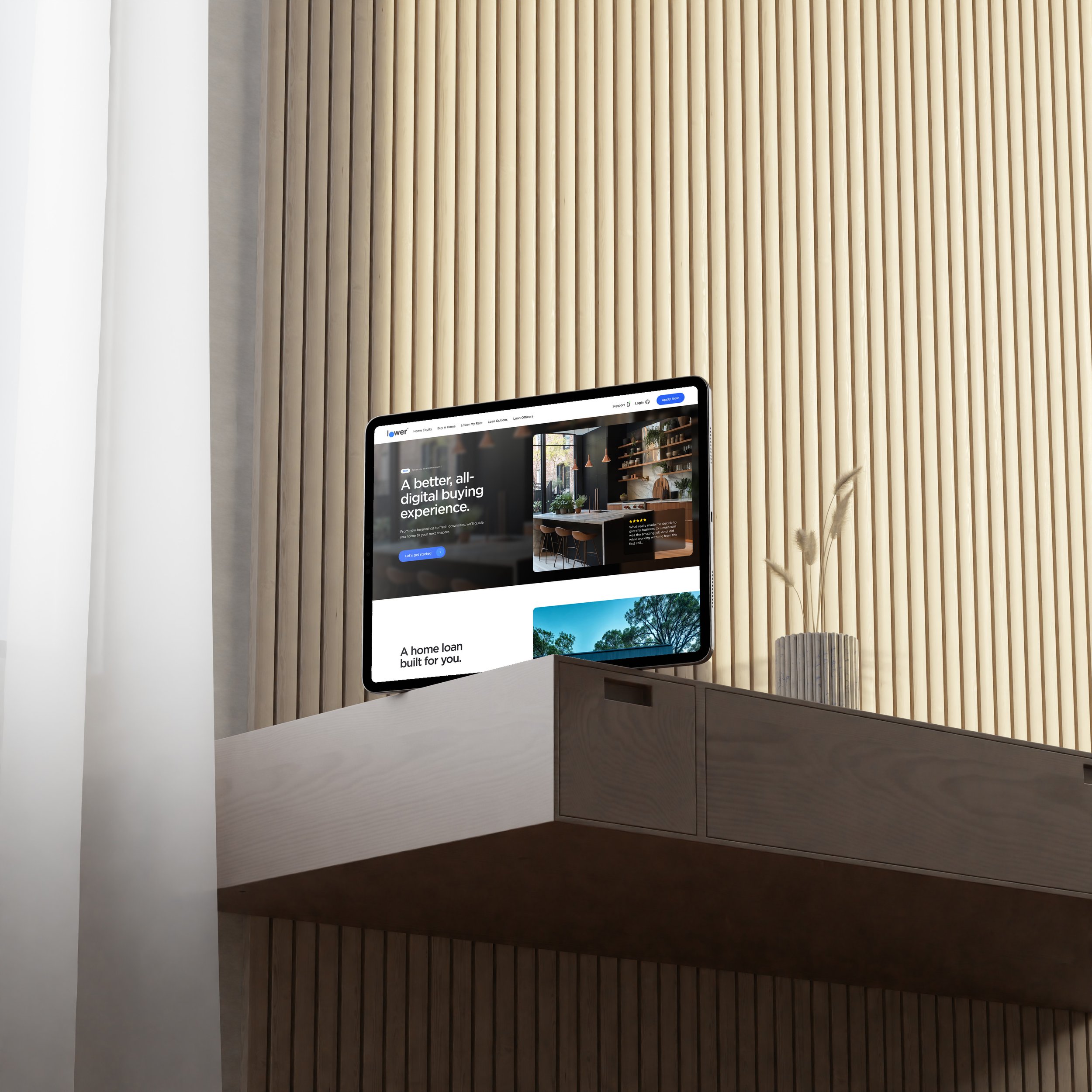 An iPad displaying a website, placed on a white floating shelf in front of a wooden slat wall, with a small potted plant nearby.