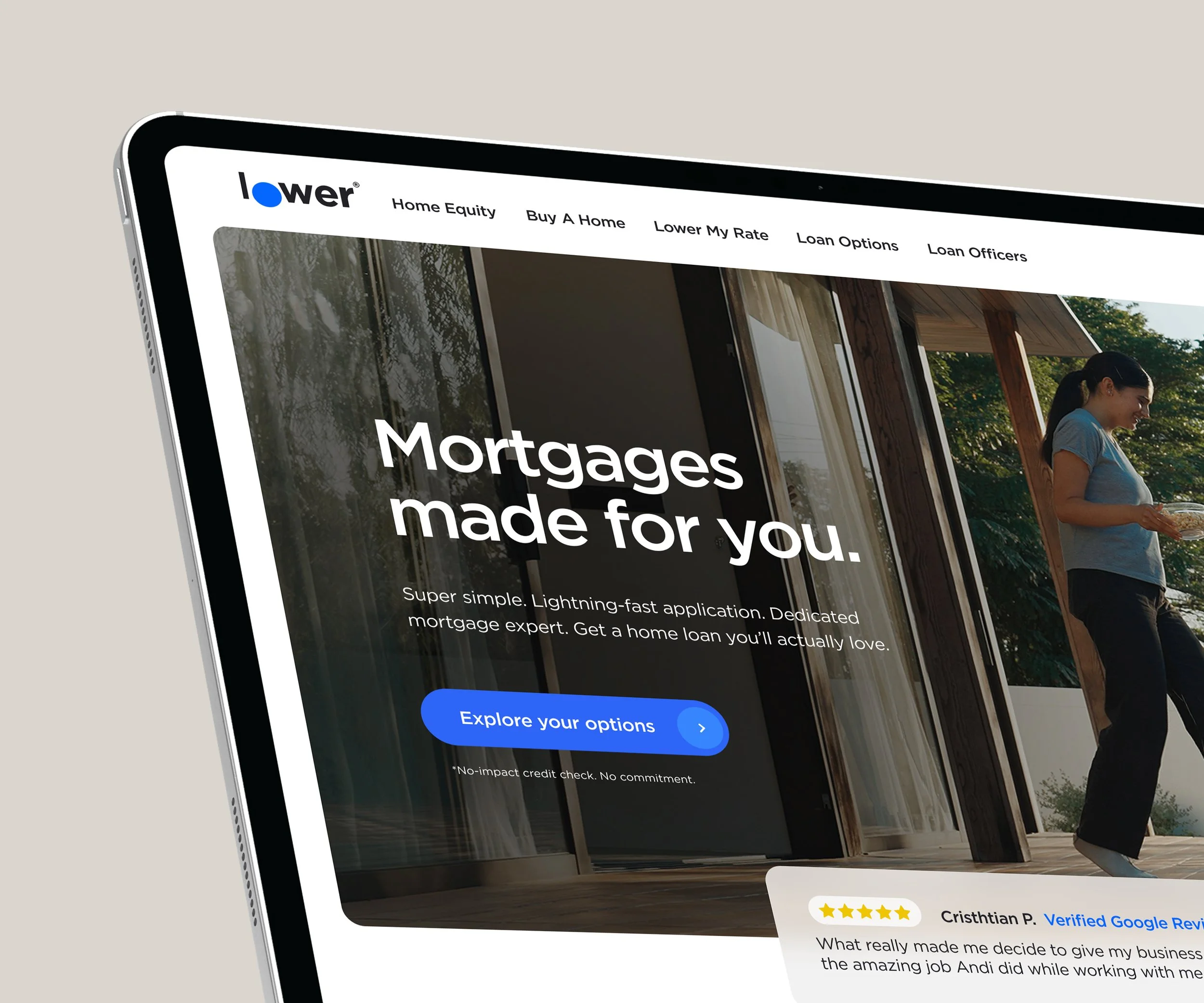 A laptop displaying a mortgage website with a woman standing outside on a porch.