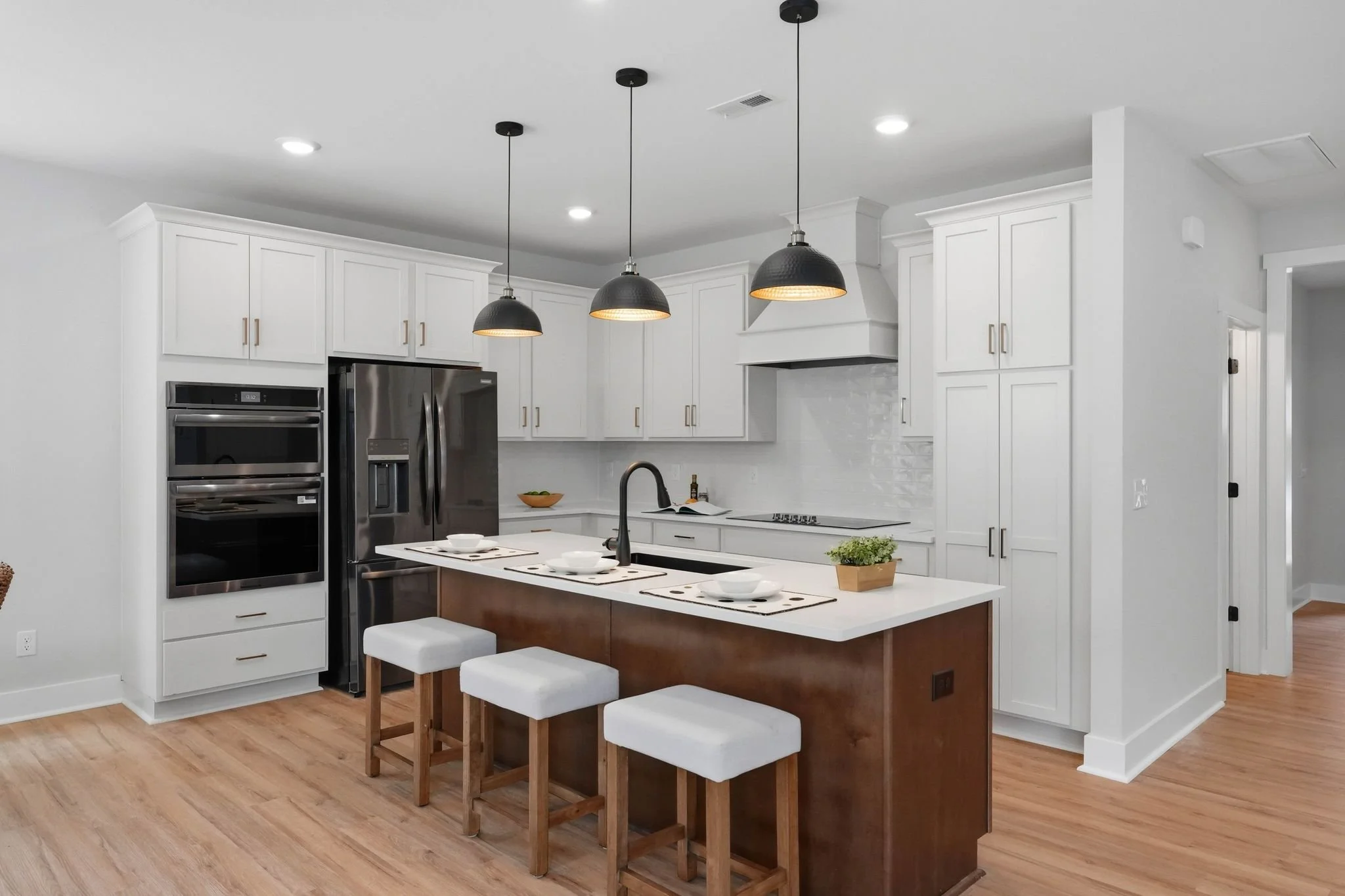 Designer kitchen white cabinetry, black accents and large island