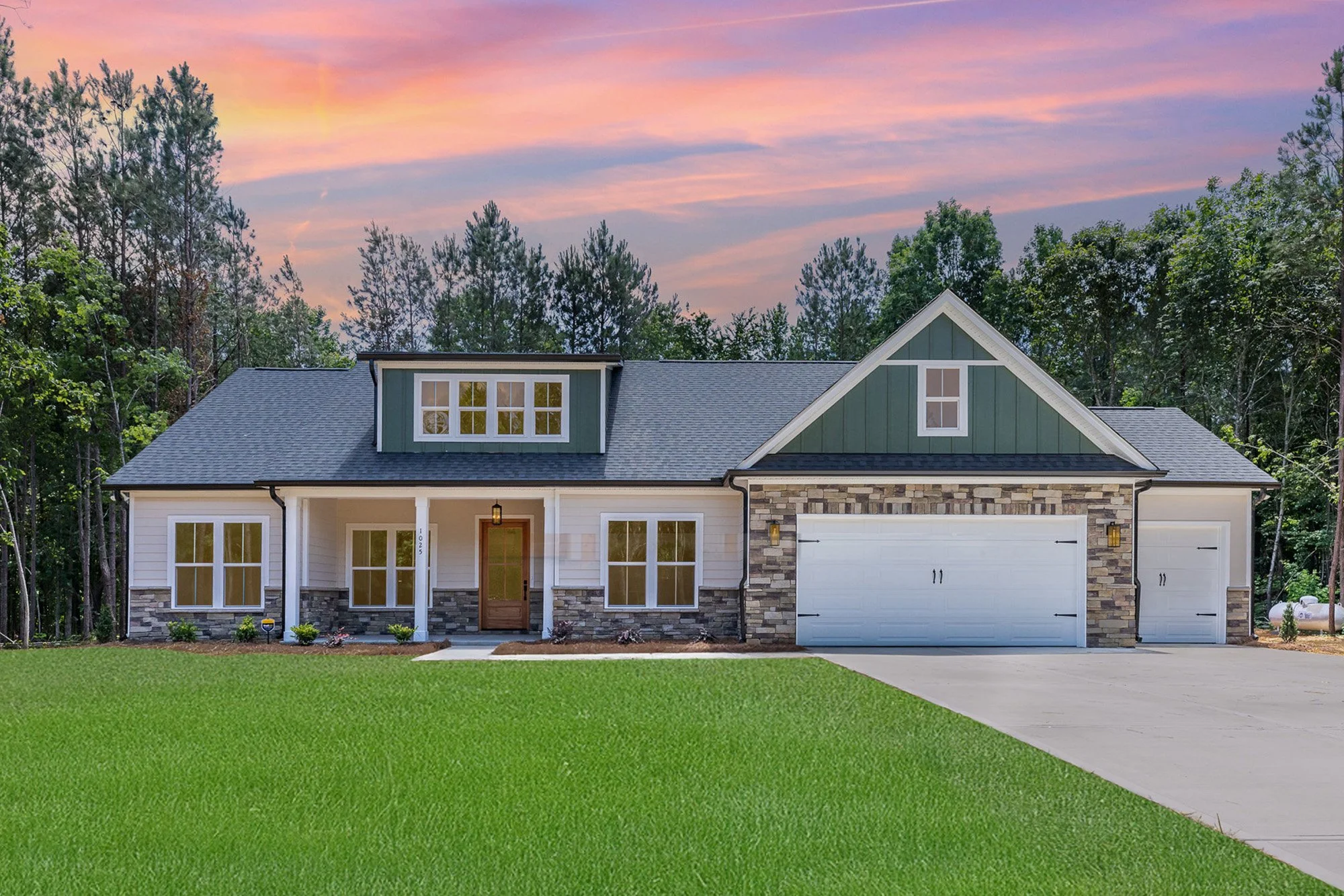 new construction home with white exteior, green accents and stone features in the Baylor Grove neighborhood