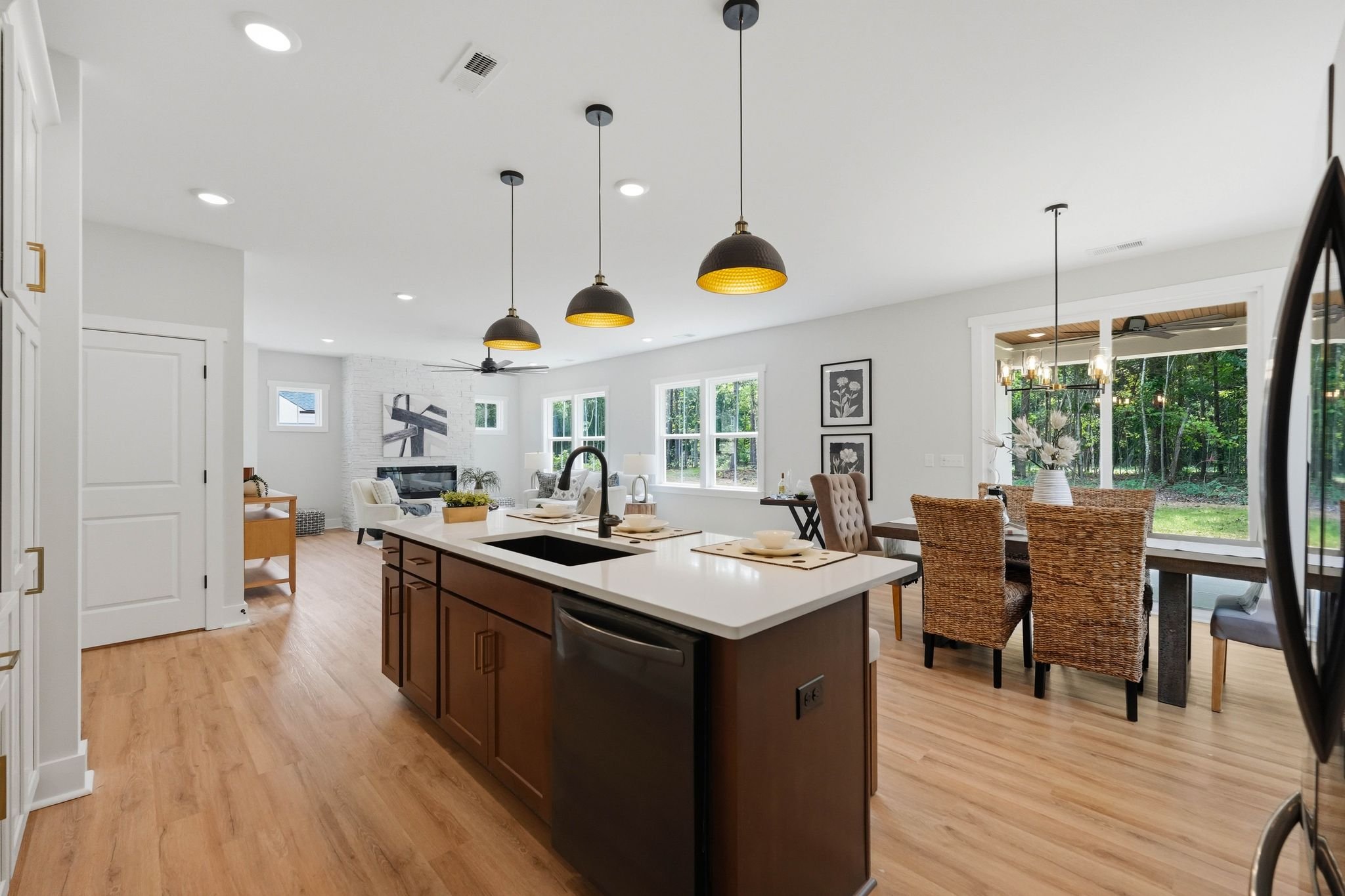 Large kitchen island with view of dining area and windows to backyard