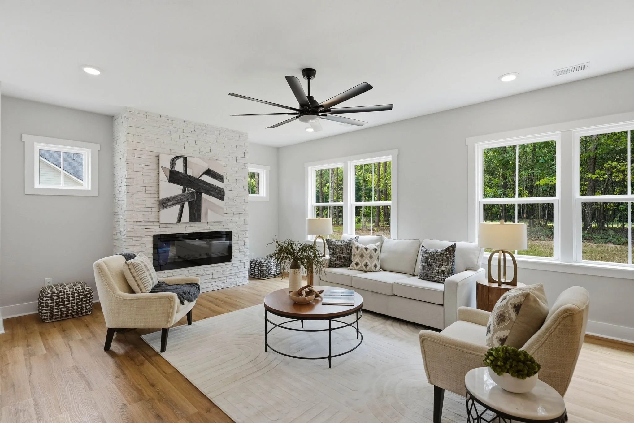 Living area with couch, chairs and fireplace in a new construction home