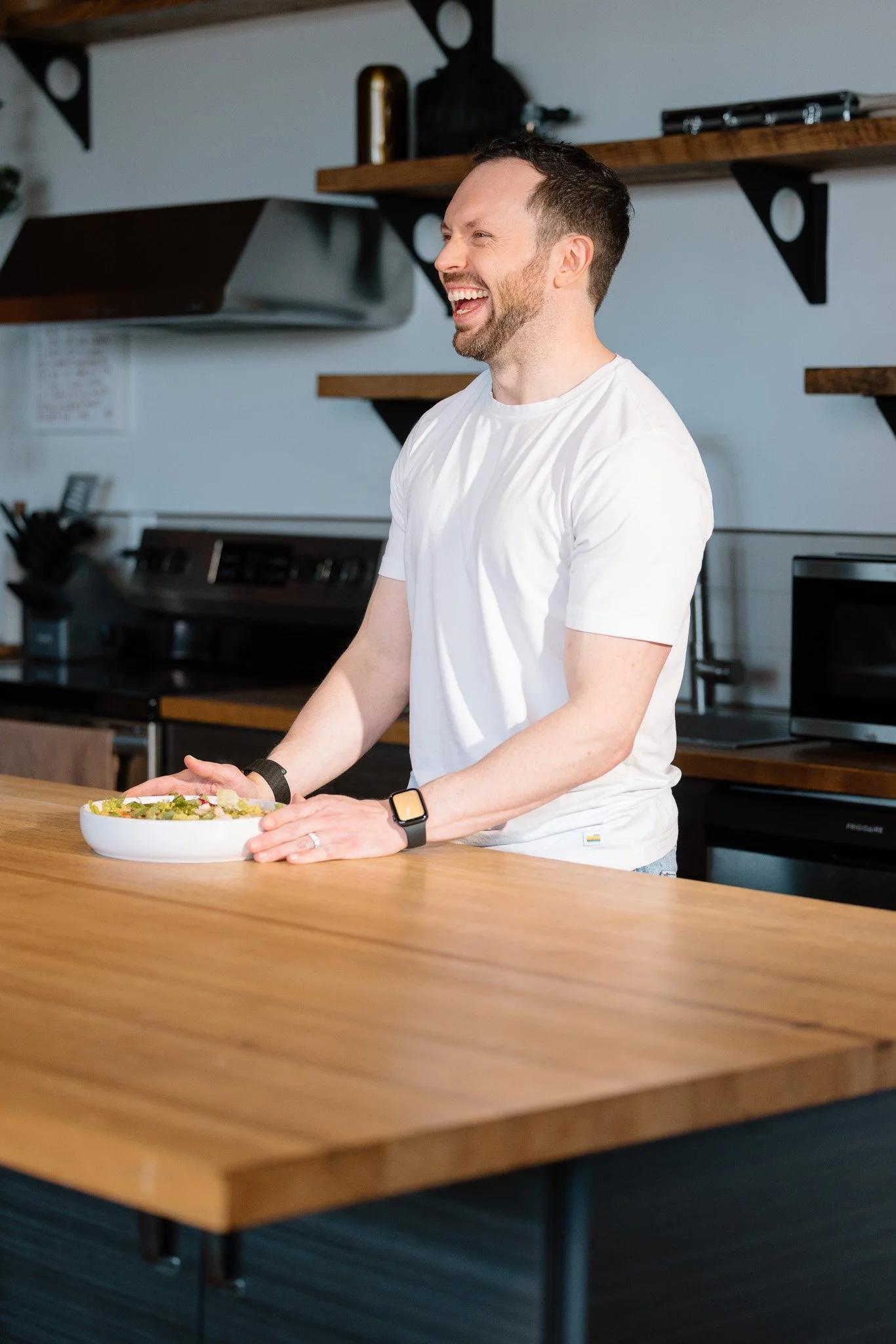 Rise Nutrition founder laughing in a modern kitchen during brand content shoot — lifestyle and nutrition brand photography by Signature Narratives, Ohio"