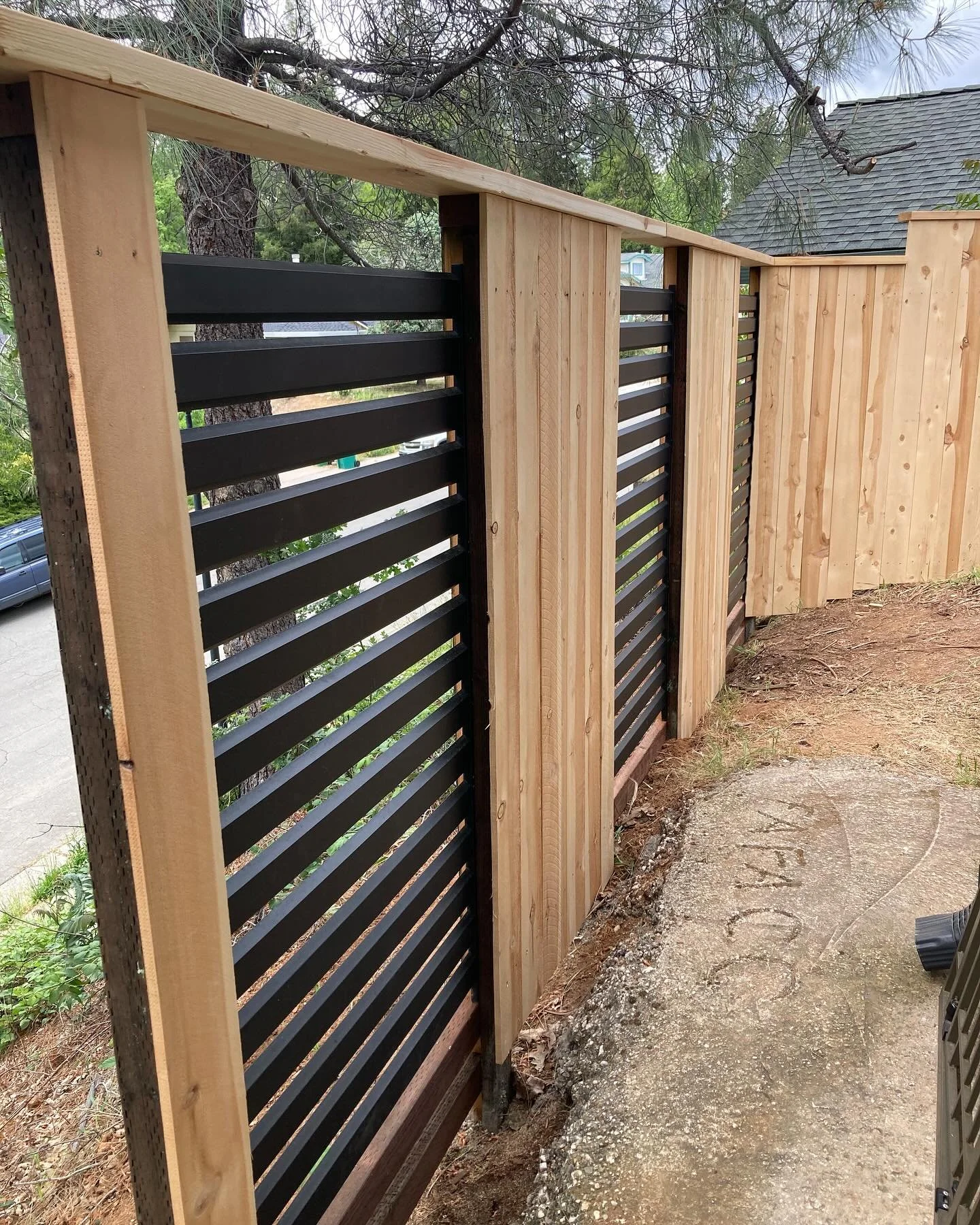 Another custom fence! Customer had these metal panels laying around so we worked them in. Turned out good!