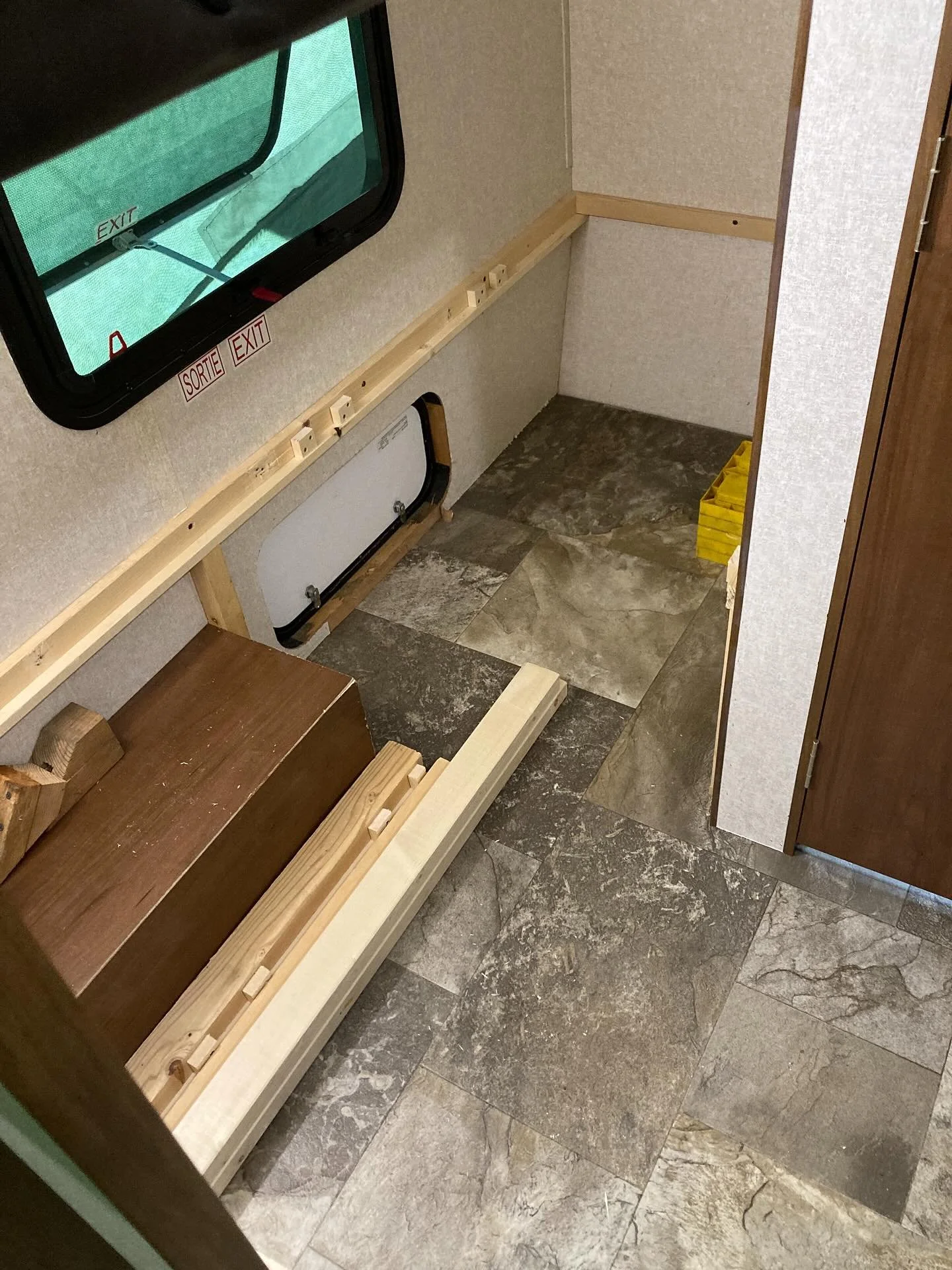Modified a trailer so that the built in bottom bunk could be removed and used as storage space and then quickly reassembled. Plywood and pad go back down and you can sleep again!