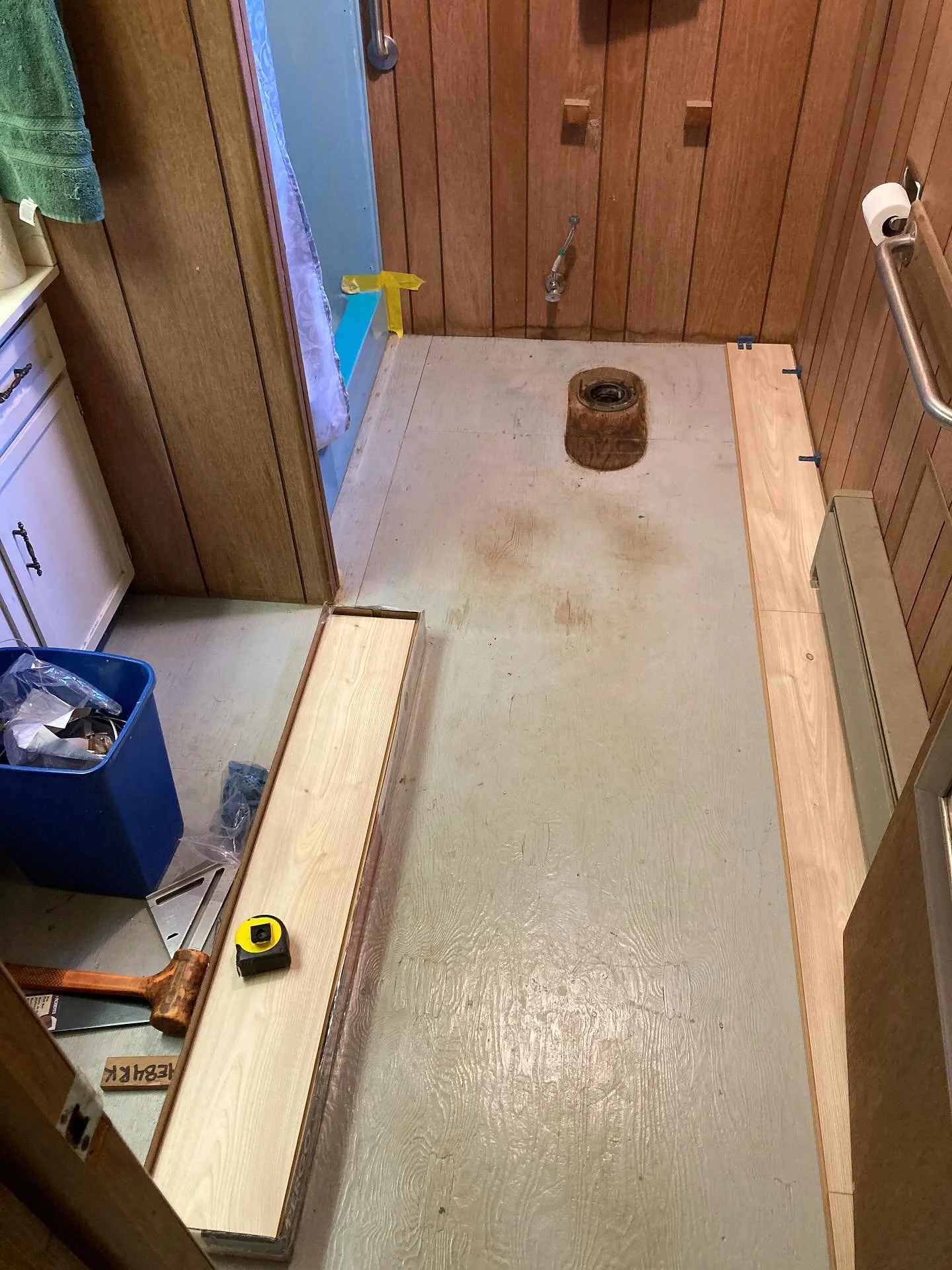 Laminate floor installed in bathroom + new wax ring for the toilet. Ready for trim.