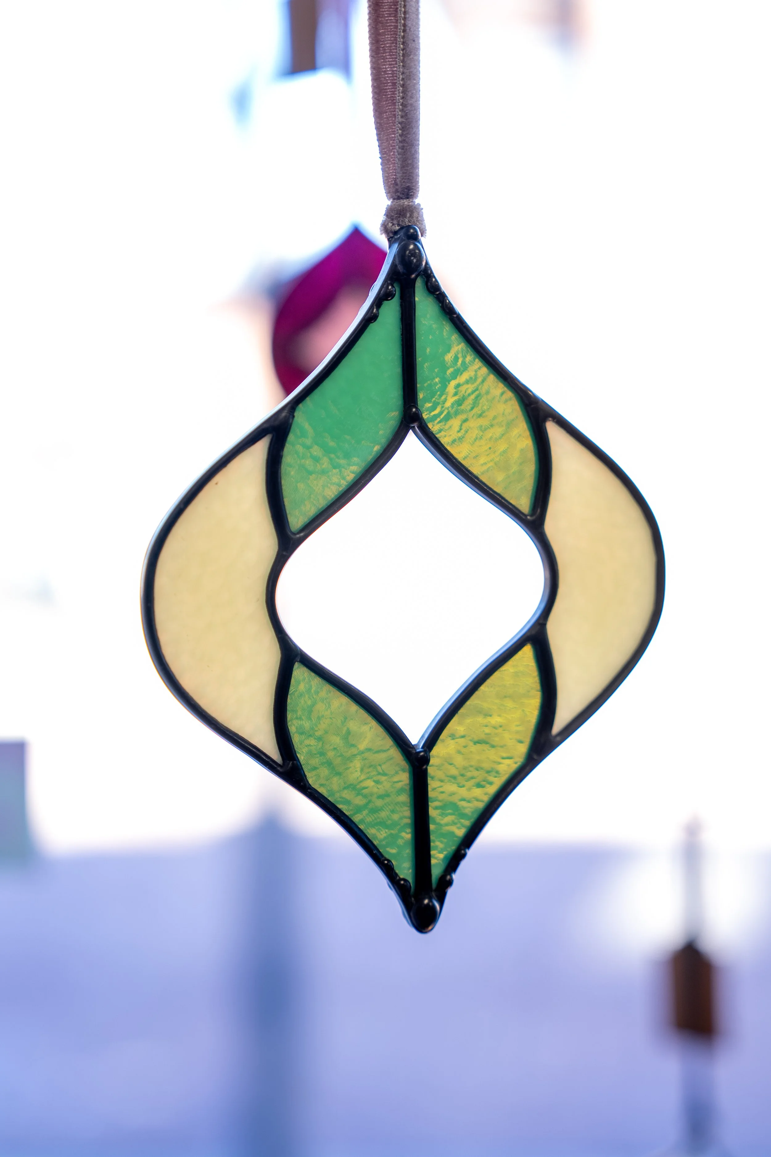 stained glass hanging in the window by artist Kate Hay
