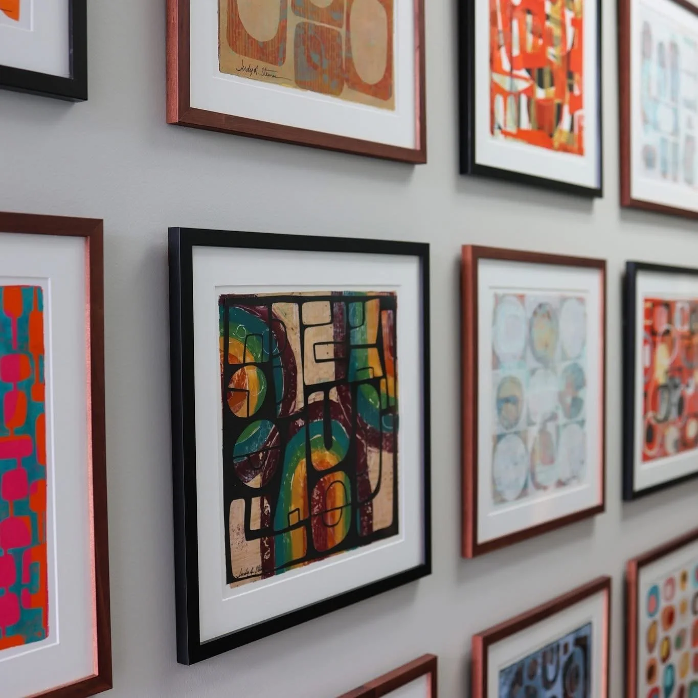 grid of 12 framed 12x12 collages by artist Judy Steiner