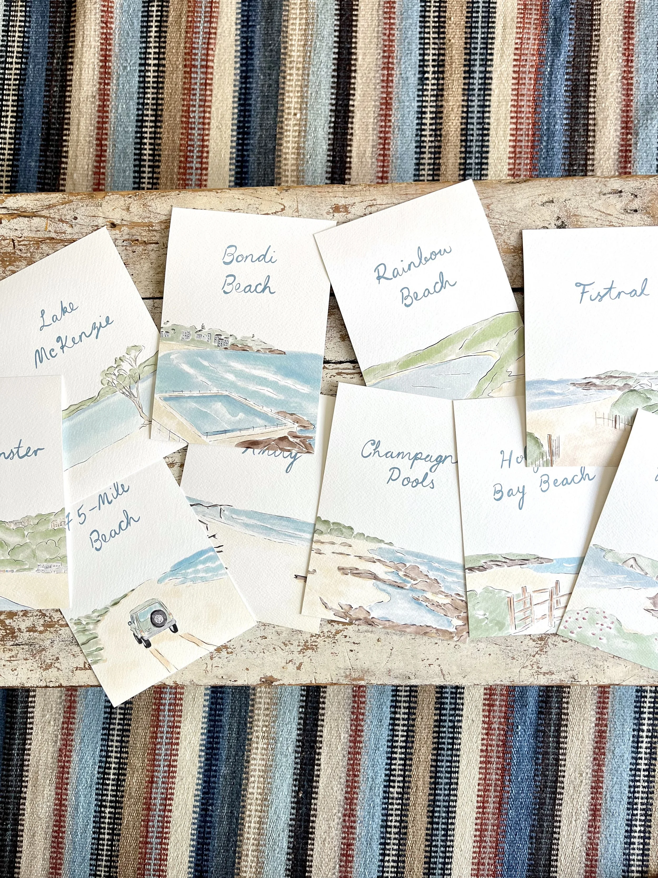 Bespoke watercolour illustrations of various beaches with handwritten labels for a wedding in Cornwall