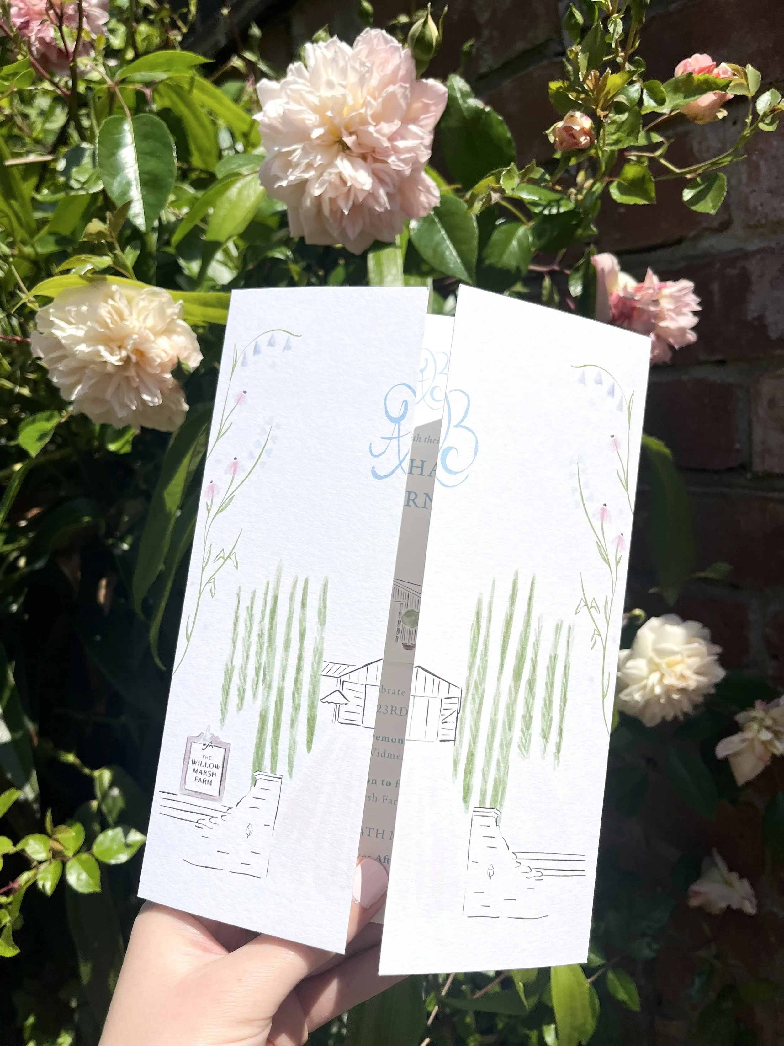 A bespoke gate-folded invite for a wedding at Willow Marsh Farm featuring a bespoke floral couples logo and wedding venue illustration