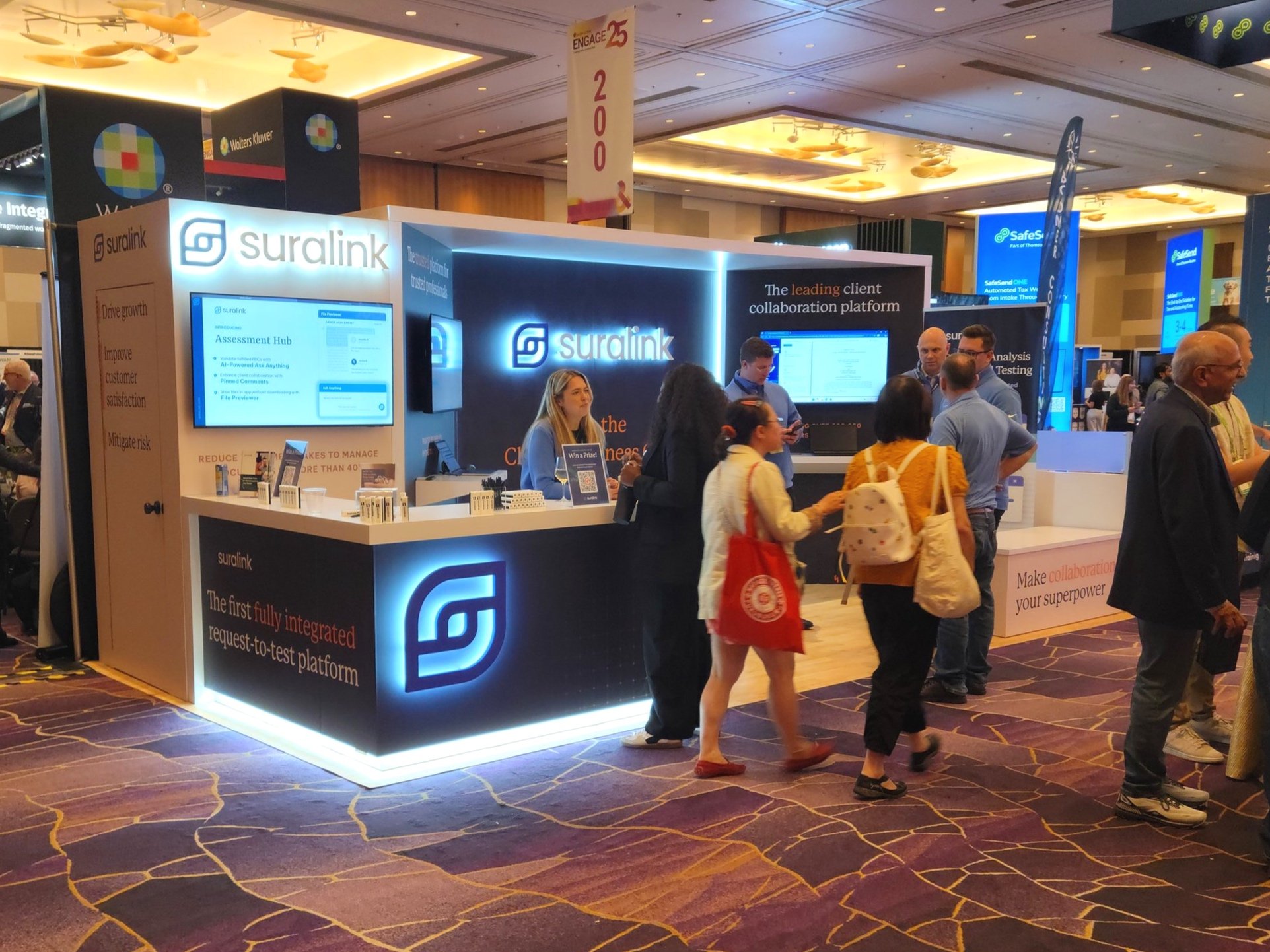 Booth in action at the beginning of the show. L Counter with lit logo and toe kick. Main monitor displaying video, other monitors ready for spontaneous presentations.