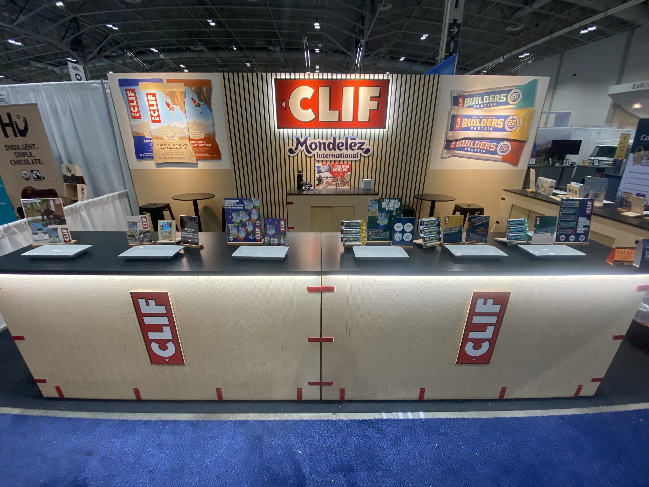 Mondelez's new booth for CHFA East 2024. Customized 'Snap Cabs' with under counter lighting, custom colored clips, and new Slat Wall.