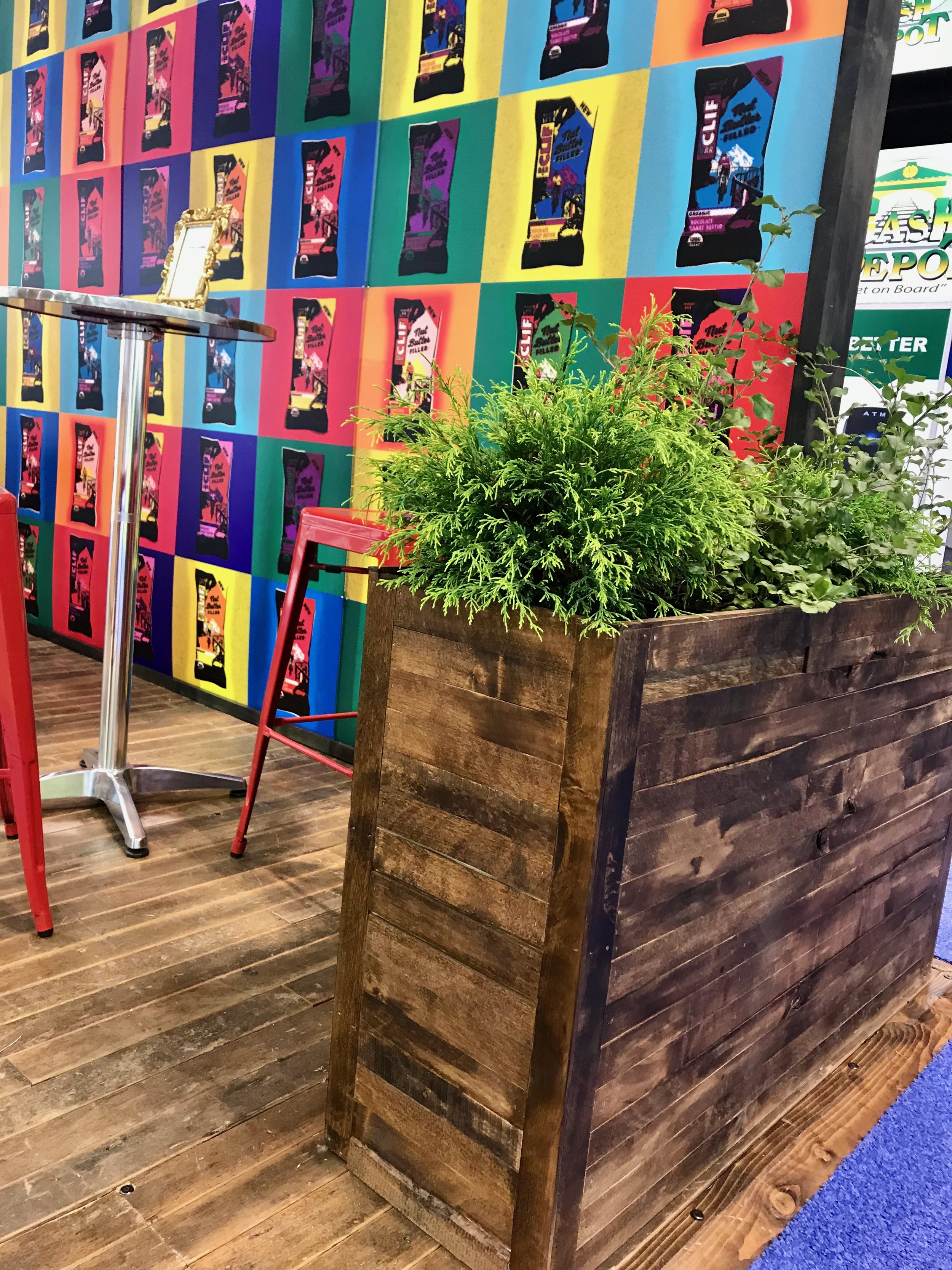 Reclaimed wood planters filled with live plants adding Clif's requisite greenery enlivening a wonderfully comic display