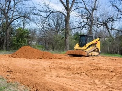 Construction site with a bulldozer and dirt pile