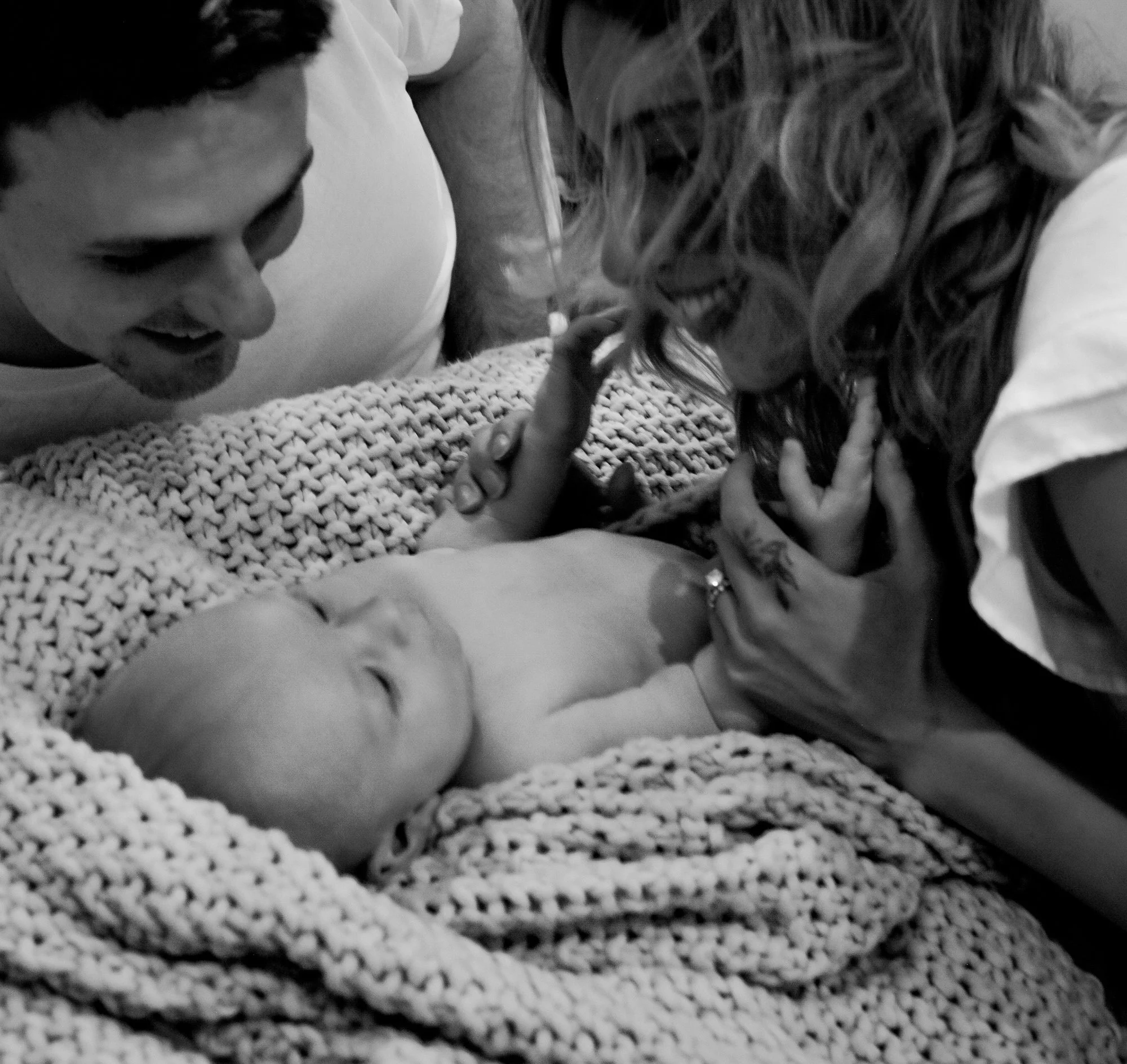 Timeless family photography featuring parents and their baby by Tucson, Arizona family photographer Rebekah Ayantola.