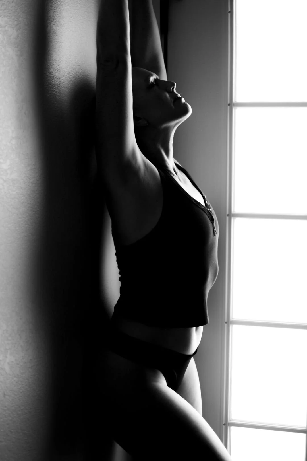 Silhouette of resilient survivor, fine art boudoir photography celebrating female empowerment