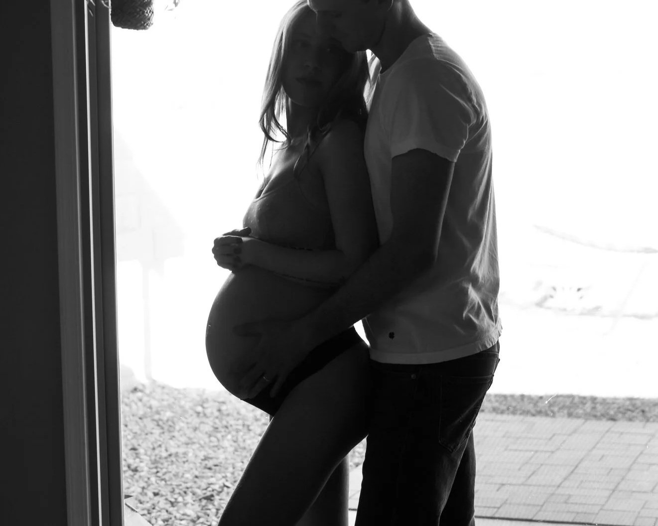 An expecting couple embracing during a fine art maternity photography session in Tucson, Arizona. Created by Tucson maternity photographer Rebekah Ayantola, this portrait highlights connection, pregnancy, and the beauty of motherhood.
