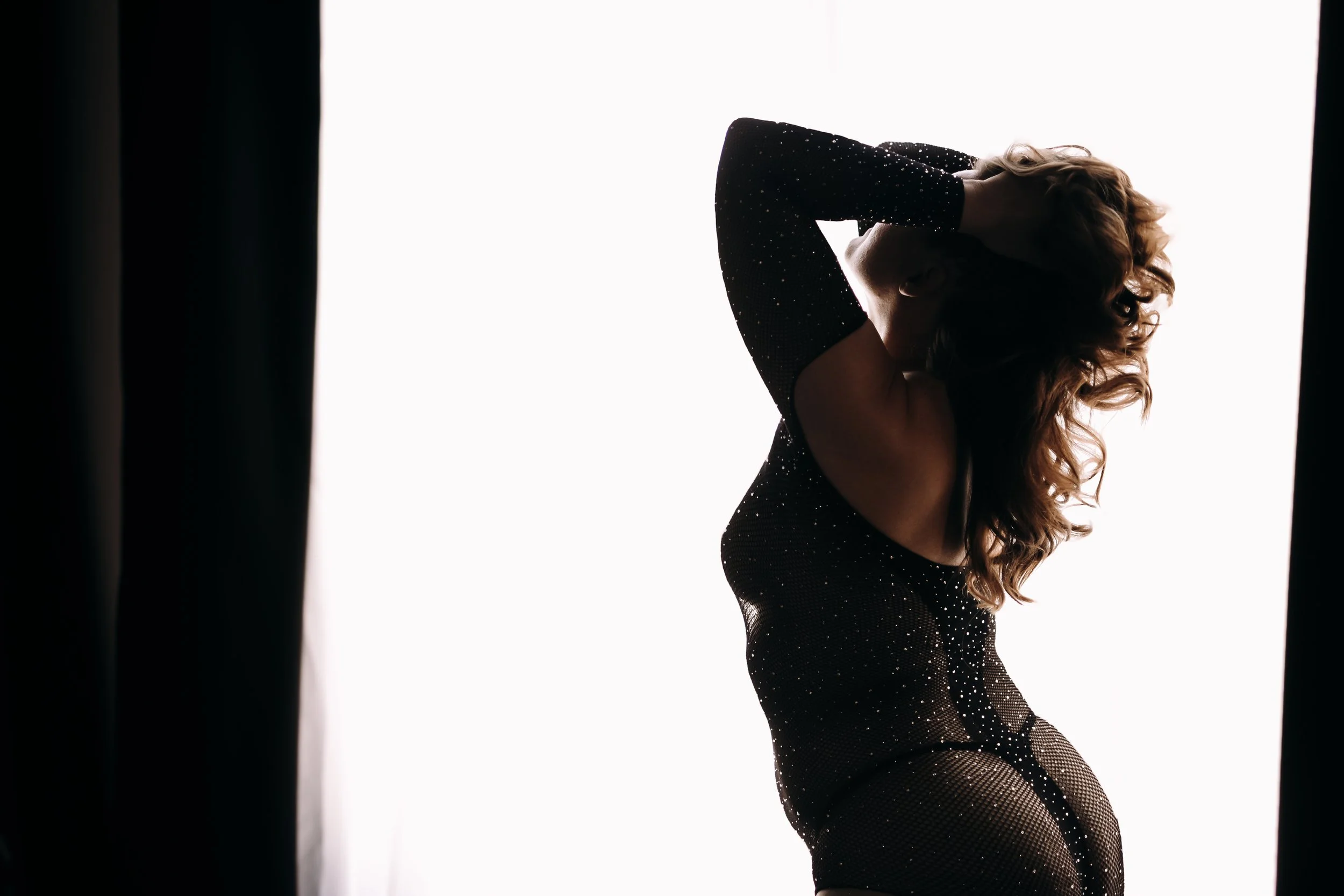 Silhouette boudoir pose in window light by number one photographer in Tucson, luxury photography
