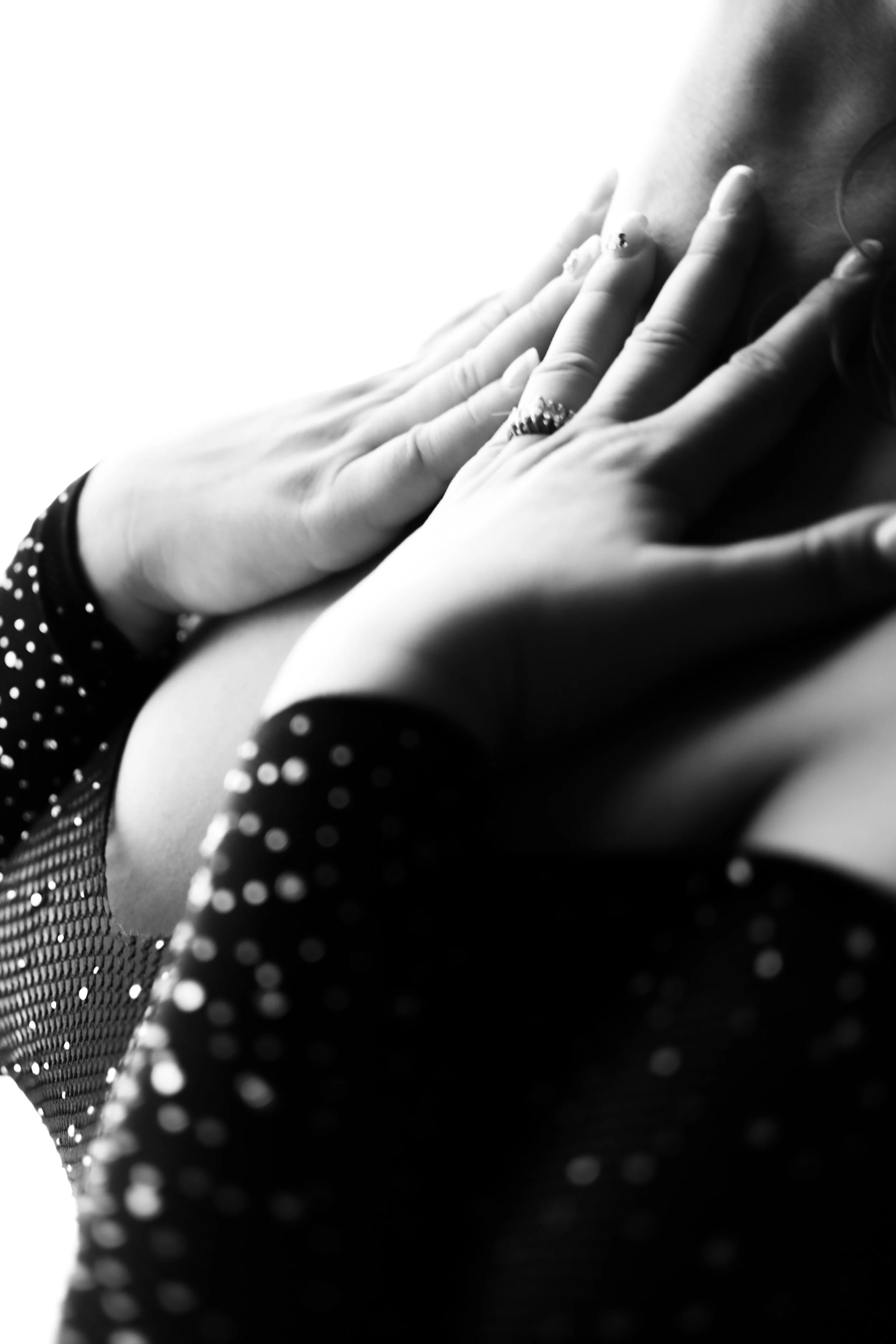 Close-up boudoir detail with hands and jewelry, captured by photographer in Tucson, fine art style