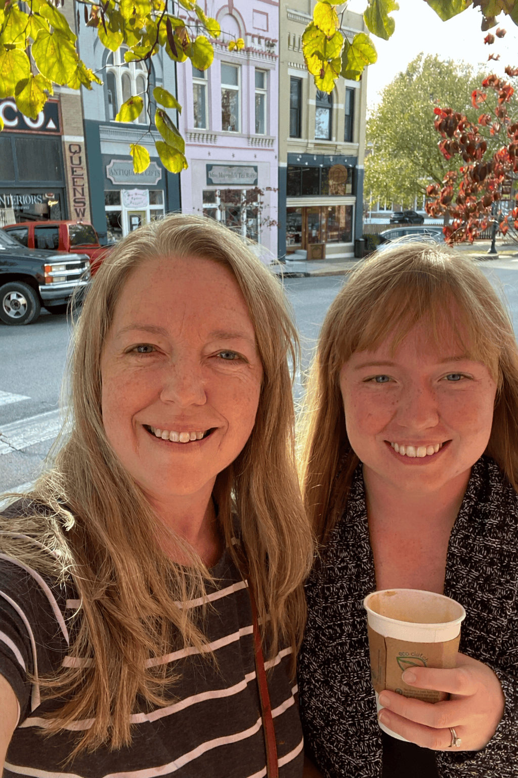 Photo of Sunflower Roots Studio Author smiling and holding a cup of coffee with CoCreator (Mom)