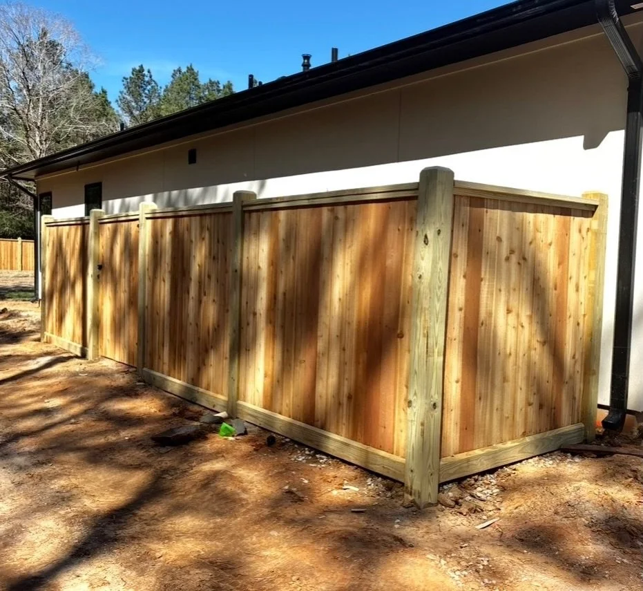 Modern privacy done right.

This cedar fence features a clean top cap &amp; trim design&mdash;giving it that framed, high-end look while adding durability where it matters most. Built with pressure-treated posts and vertical cedar pickets for full pr