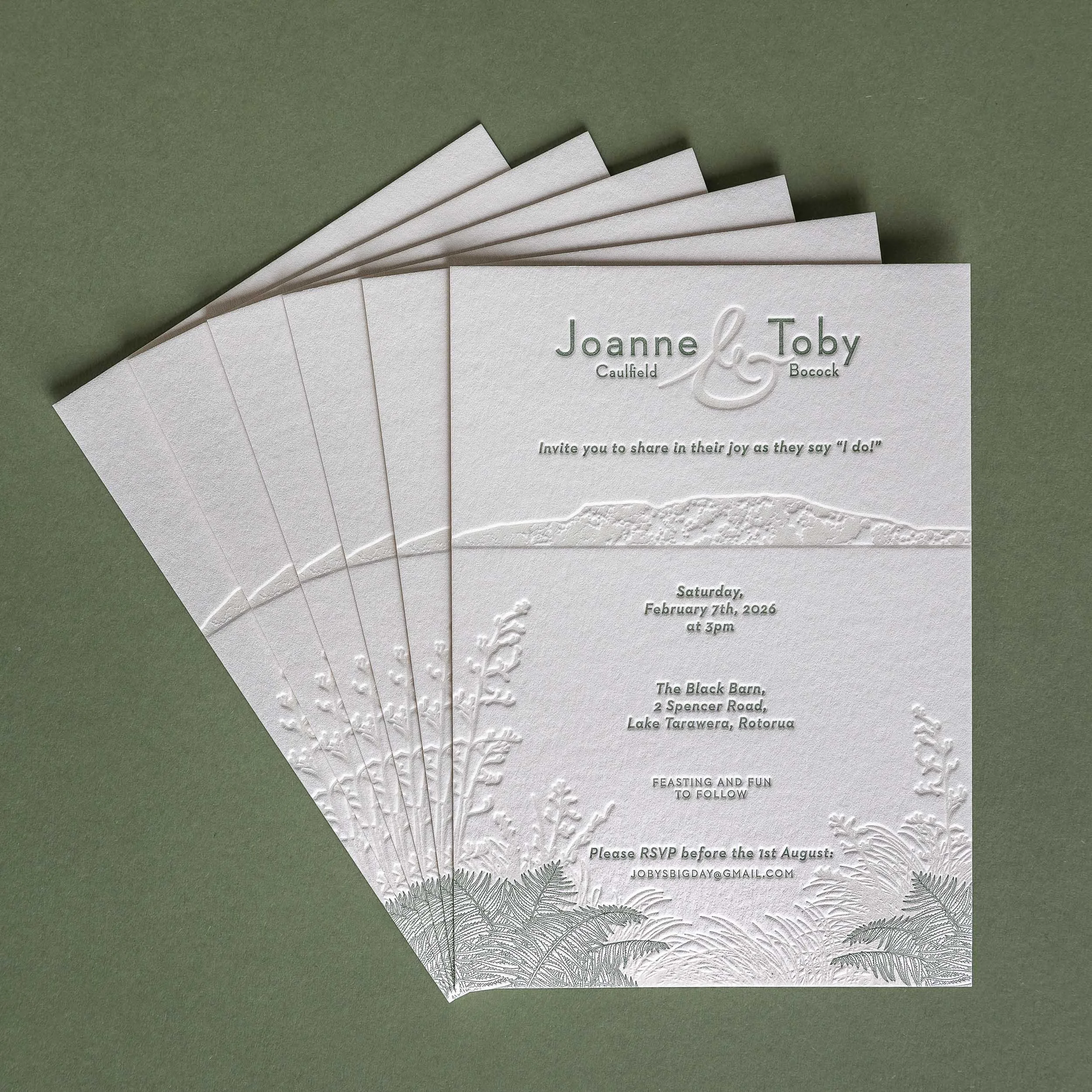 Letterpress wedding invitation featuring Mt Tarawera and native New Zealand flora, created for a wedding at The Black Barn.