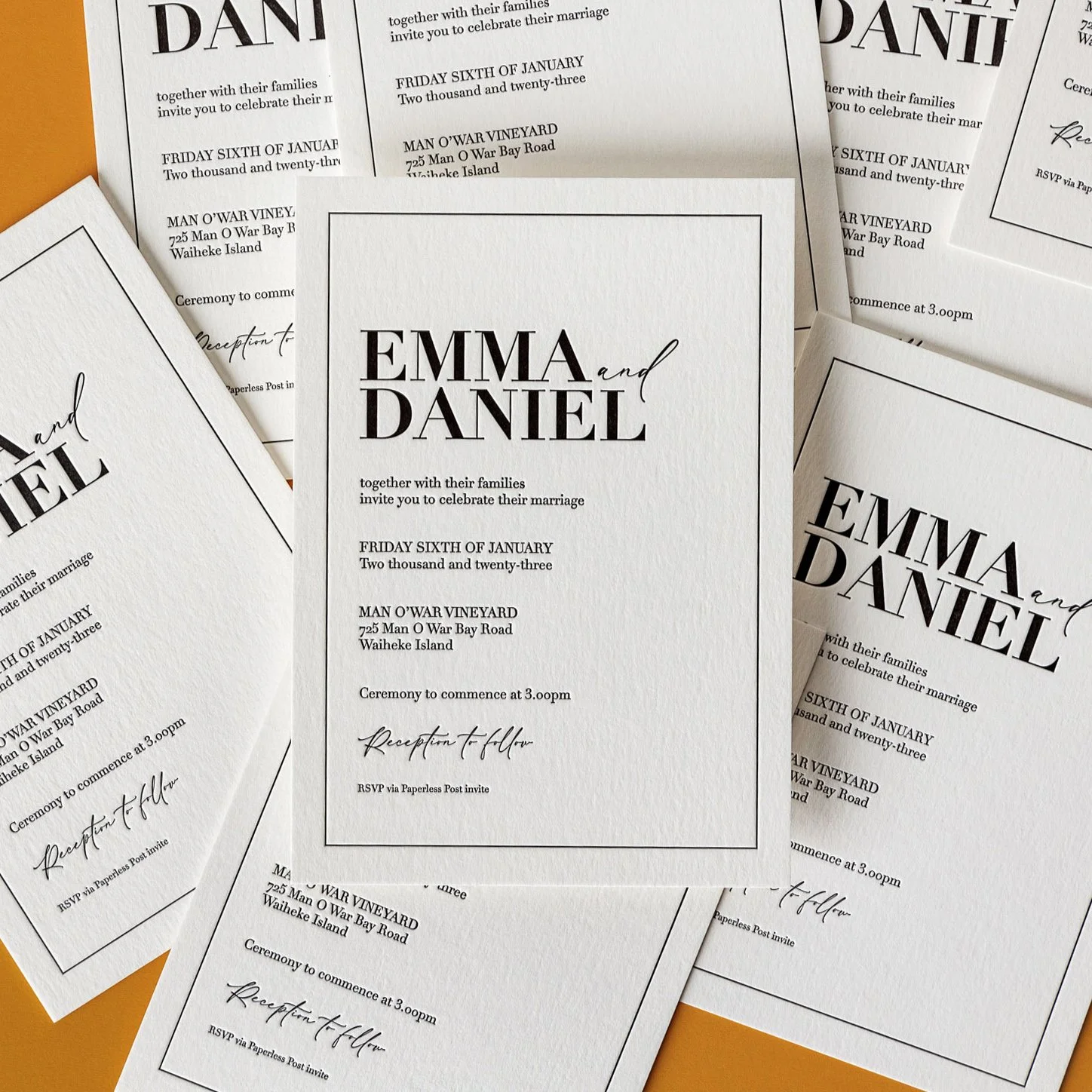Emma and Daniel's letterpress wedding invitation featuring crisp black typography on heavyweight cotton paper.