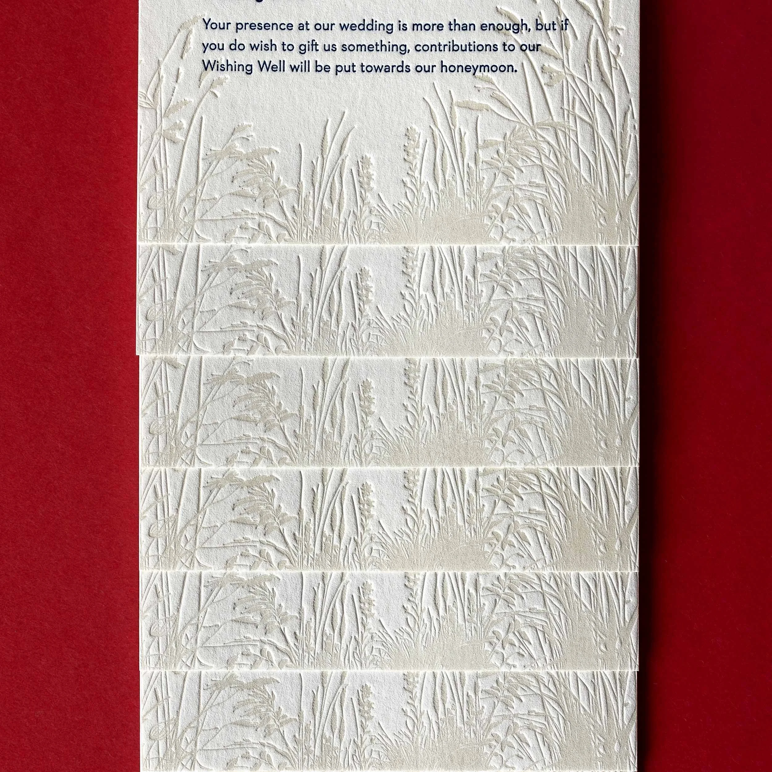 Close-up of tonal letterpress tussock grasses on Brontë and Simon’s Boomrock wedding details cards.