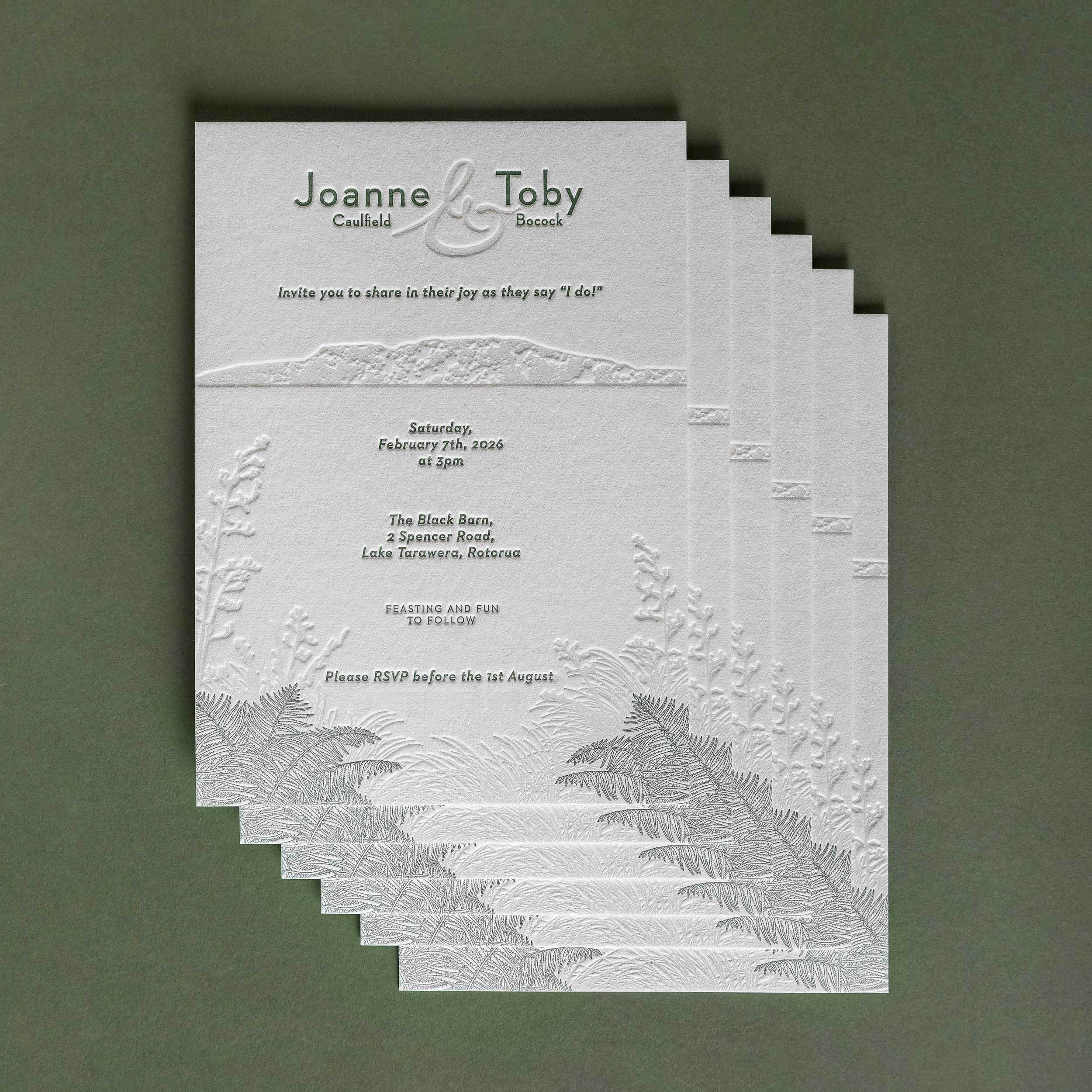 Letterpress wedding invitation featuring an illustration of Mt Tarawera and native New Zealand flora for a Black Barn wedding.
