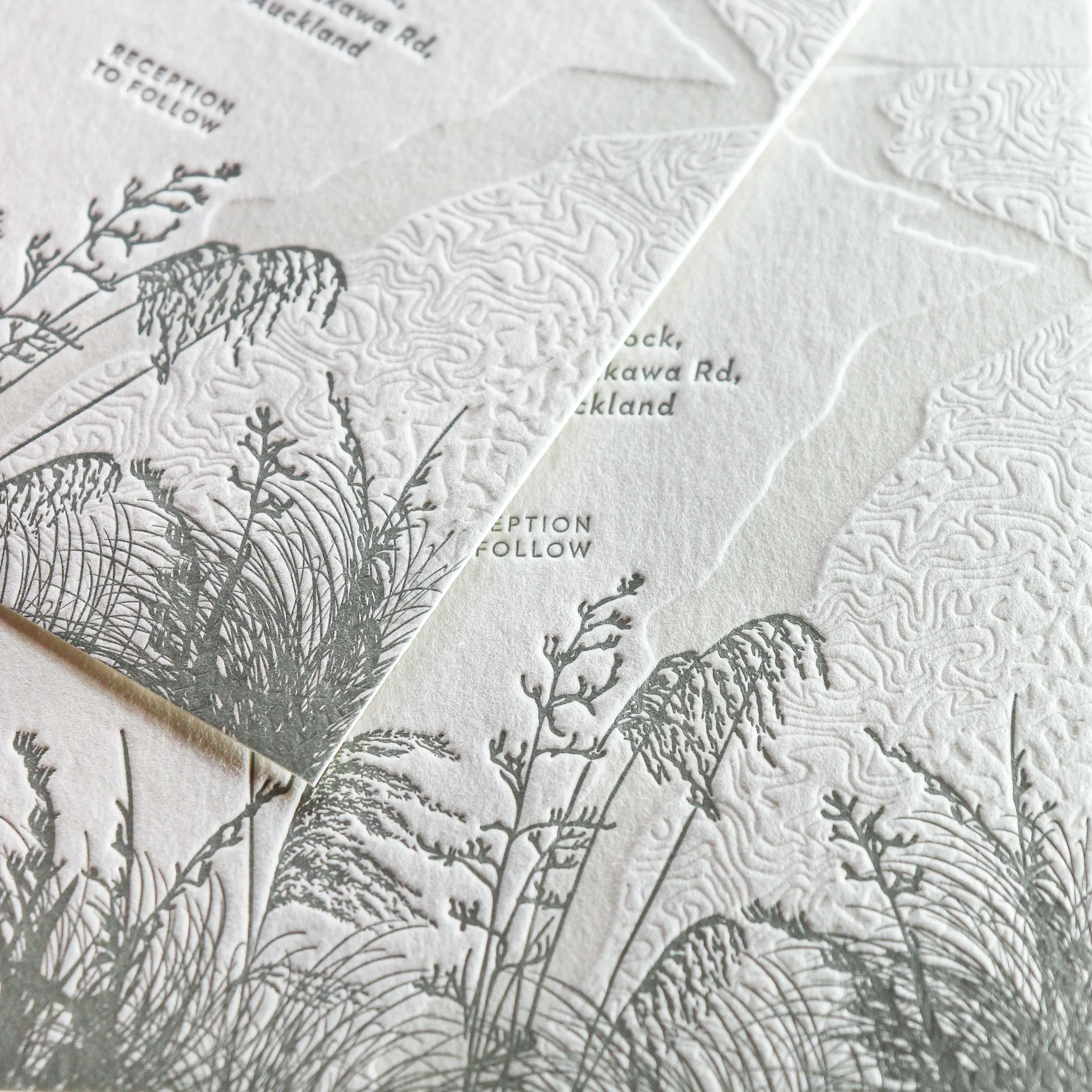 Beach-inspired letterpress wedding invitation featuring coastal native plants, printed on luxurious cotton card, designed and crafted in New Zealand.