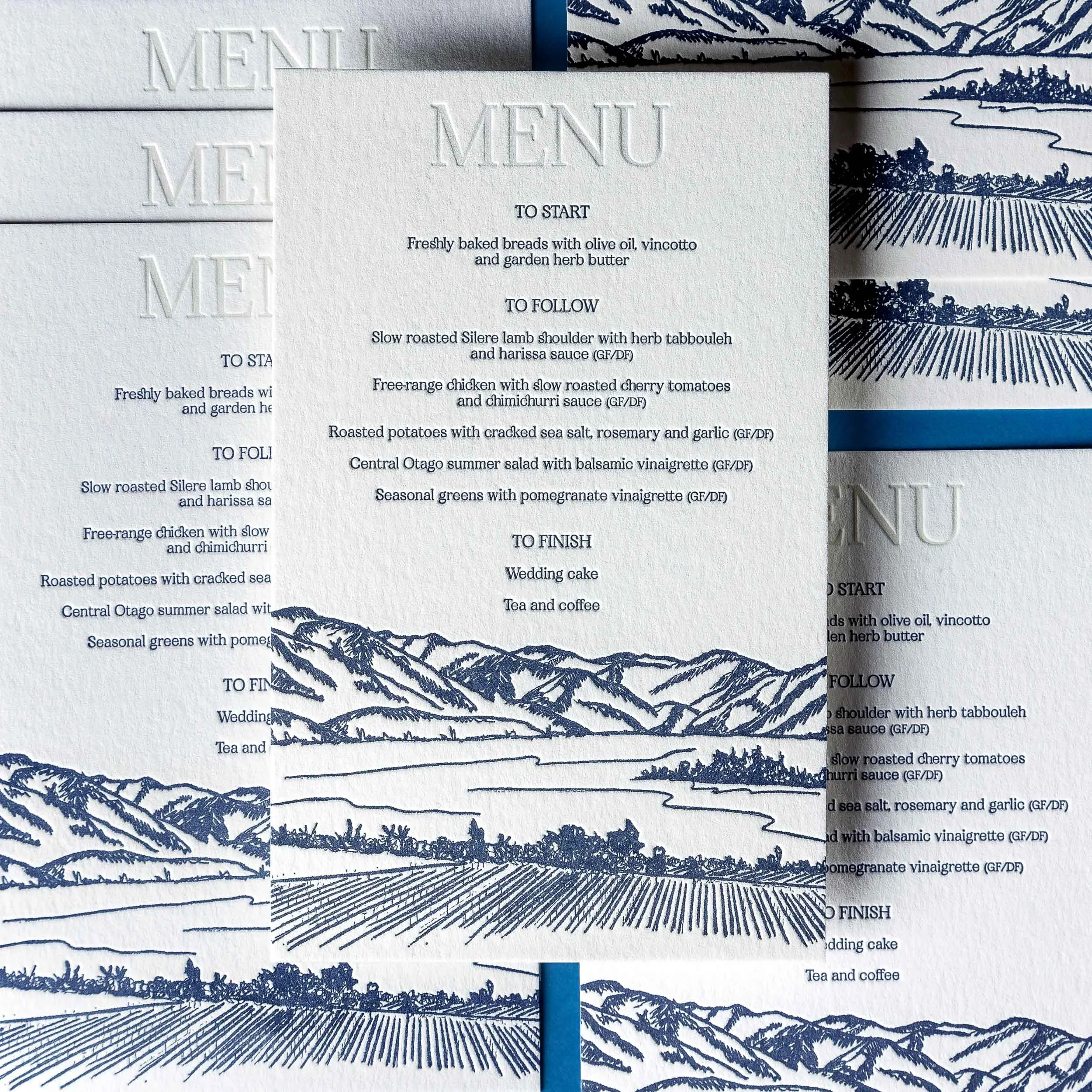 Letterpress wedding menu with blind debossed heading and hand-drawn landscape illustration inspired by Rippon in Wānaka.