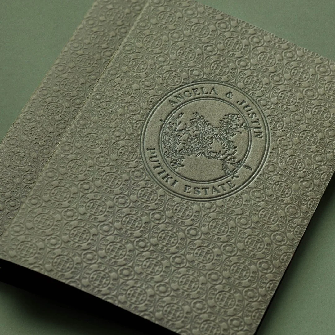 Custom letterpress wedding bar menu featuring a pattern inspired by the decorative tiles at Putiki Estate and a hand-drawn mānuka illustration.