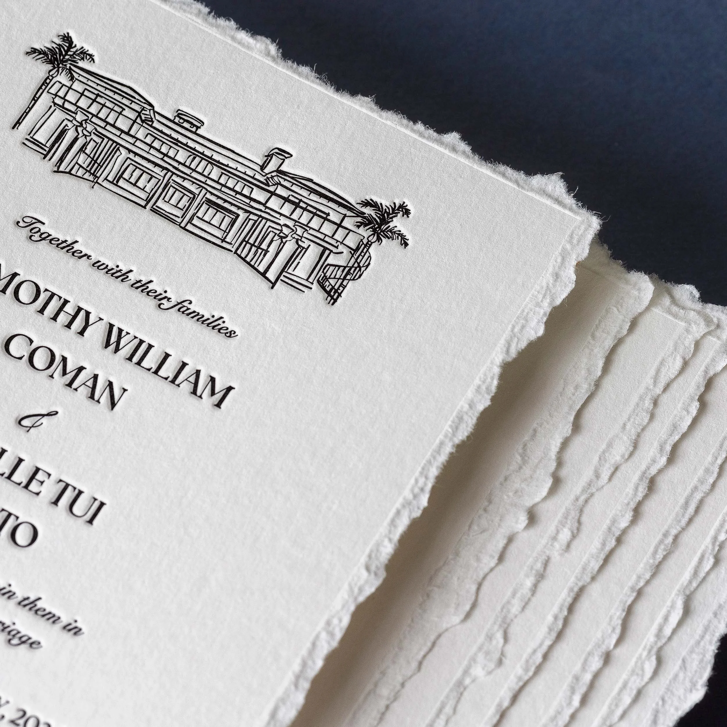 Close-up of a letterpress wedding invitation with hand-deckled edges and an illustration of Ataahua Estate.