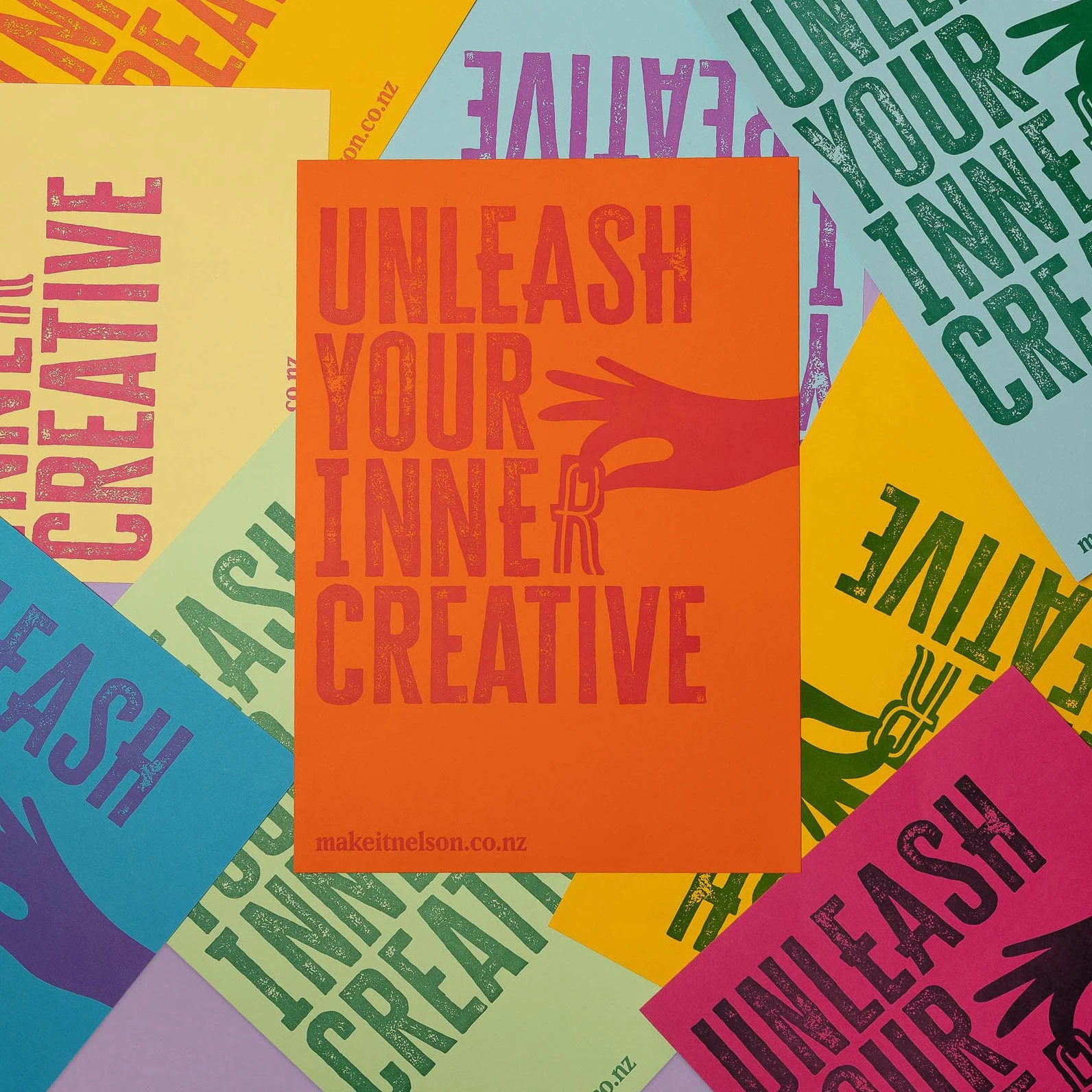 Colourful Make It Nelson letterpress posters overlapping, with the Unleash Your Inner Creative design printed in contrasting inks.