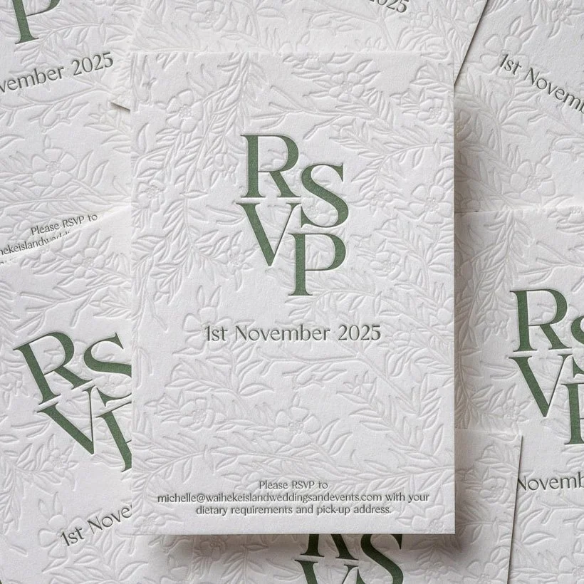 Cream RSVP cards with embossed mānuka artwork and green typography for Angela and Justin’s wedding invitation suite.
