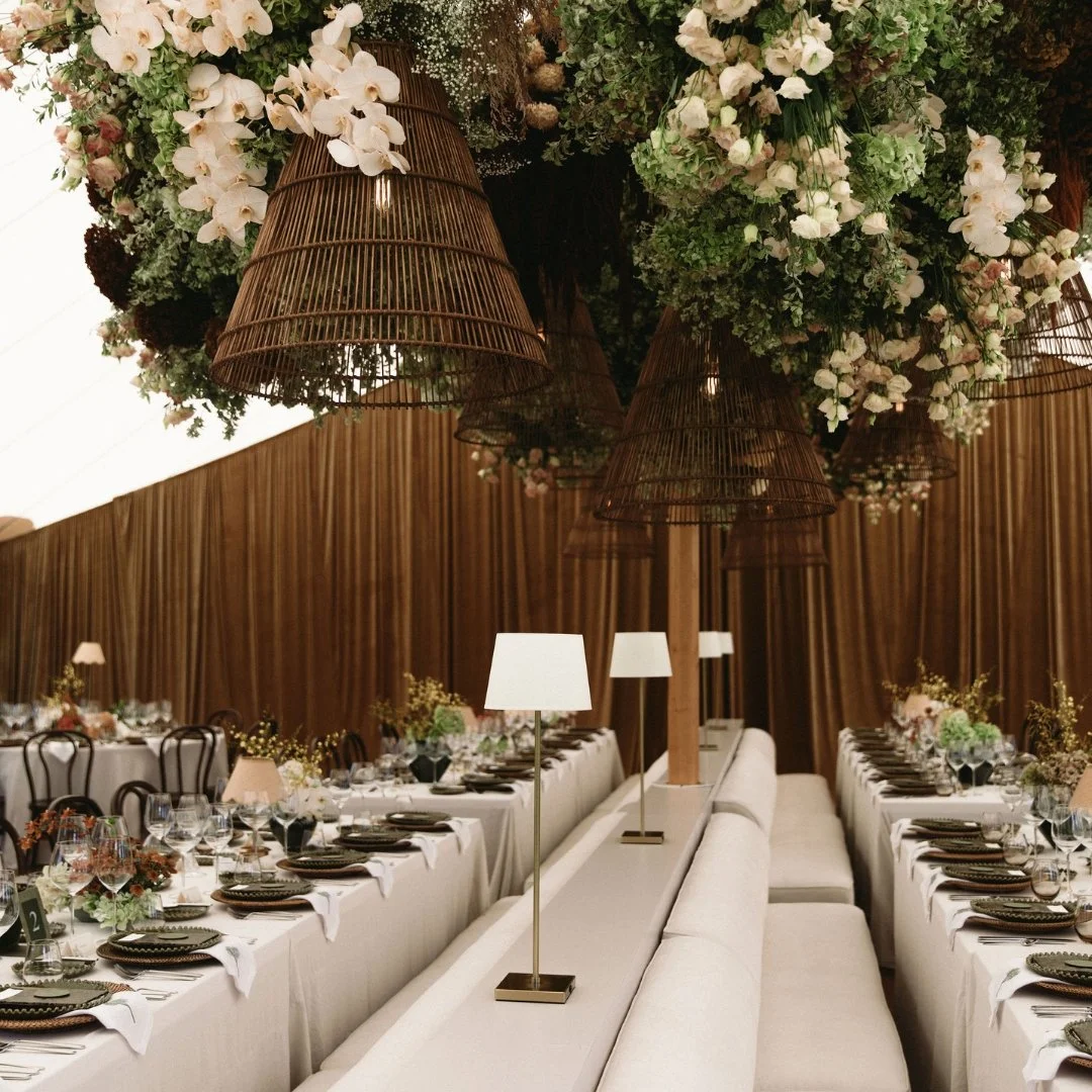 Putiki Estate wedding reception with long tables, layered place settings and floral installations.