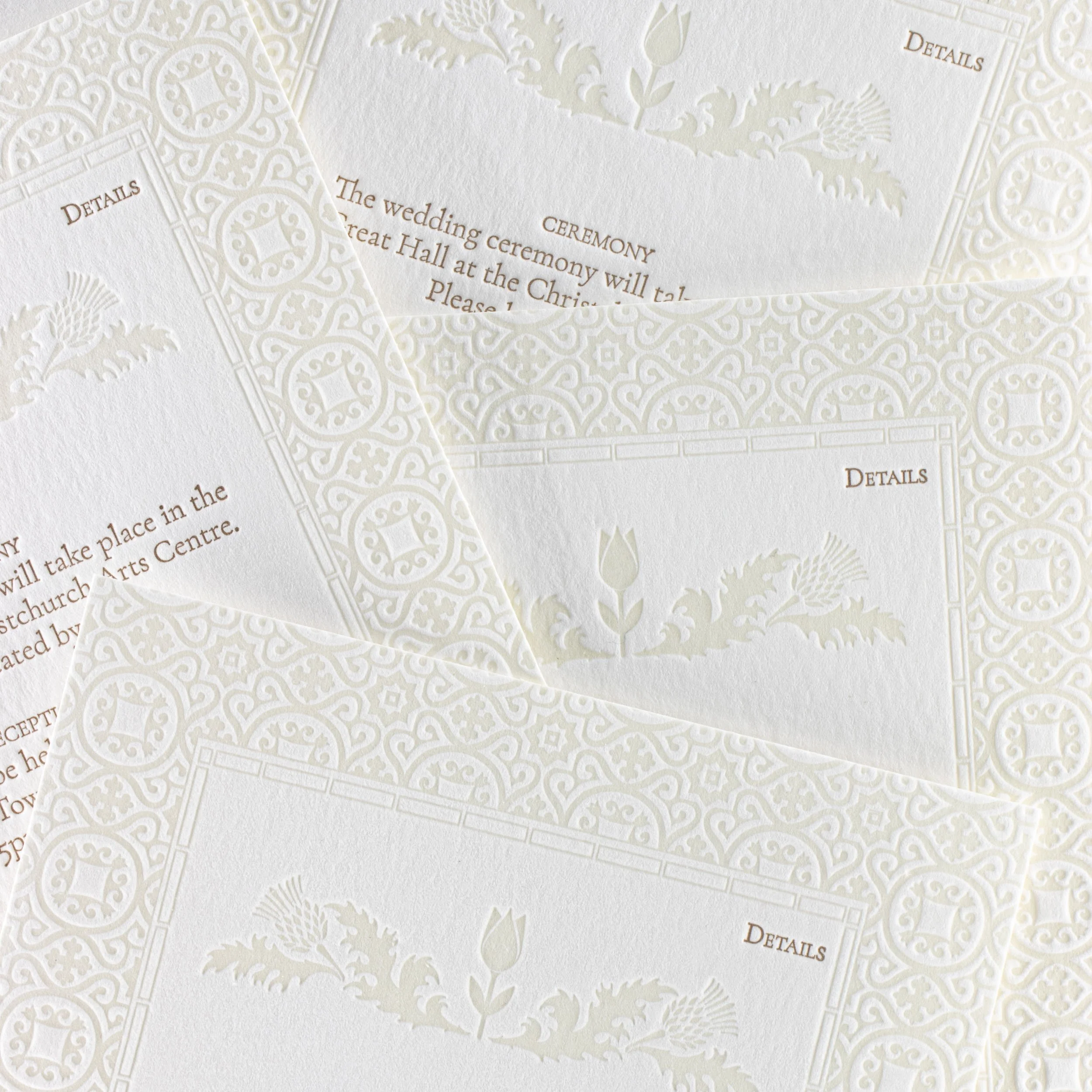 Amy and John’s letterpress wedding details cards featuring intricate debossed patterns with tulip and thistle motifs.