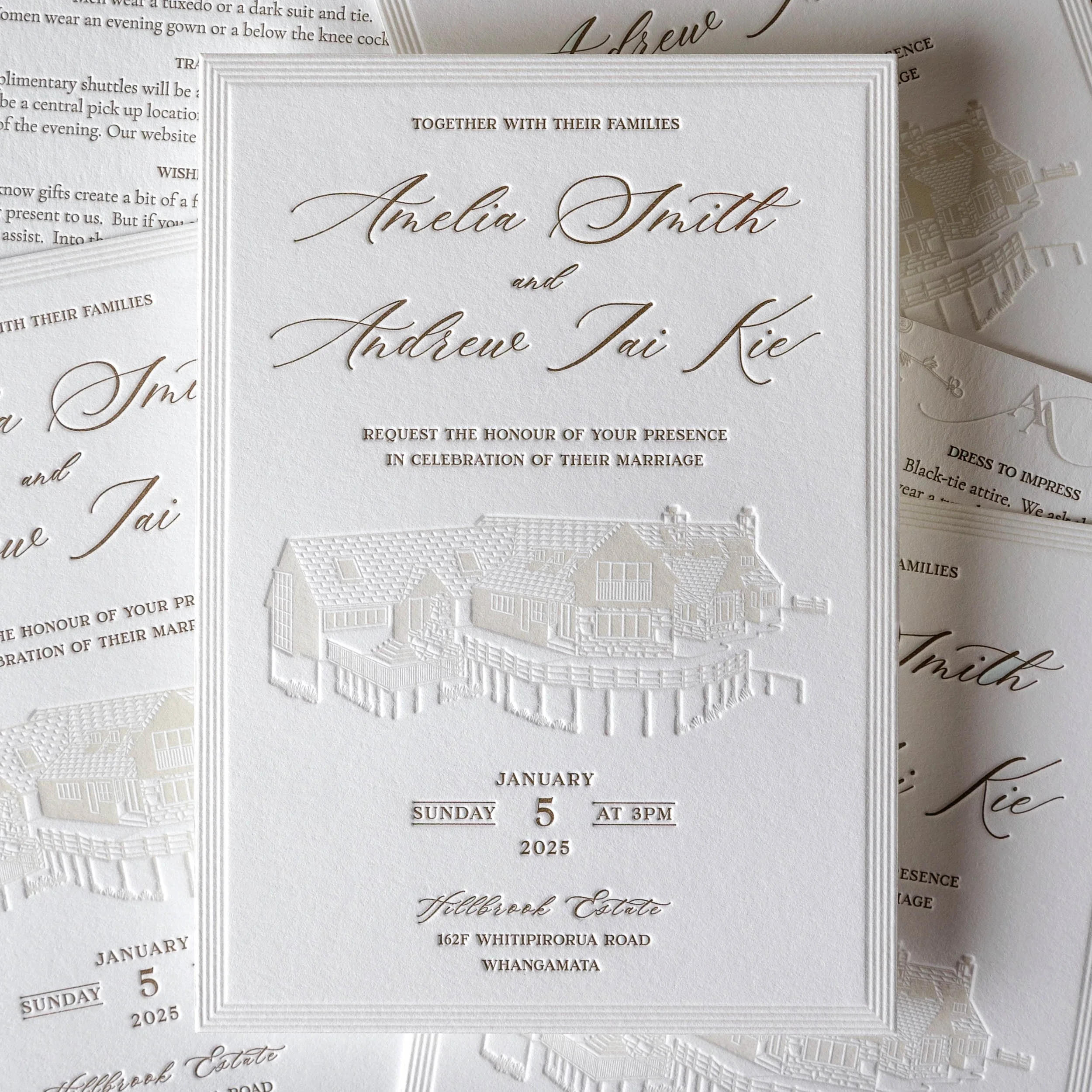 Letterpress wedding invitations for Amelia and Andrew featuring a blind deboss illustration of Hillbrook Estate and warm metallic gold typography.