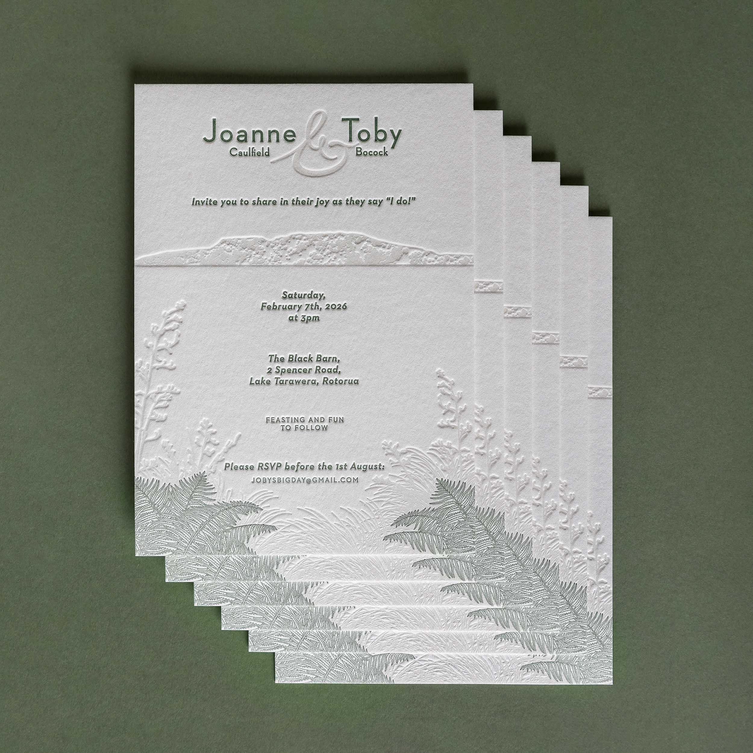 Letterpress wedding invitation featuring an illustration of Mt Tarawera and native New Zealand flora for a Black Barn wedding.
