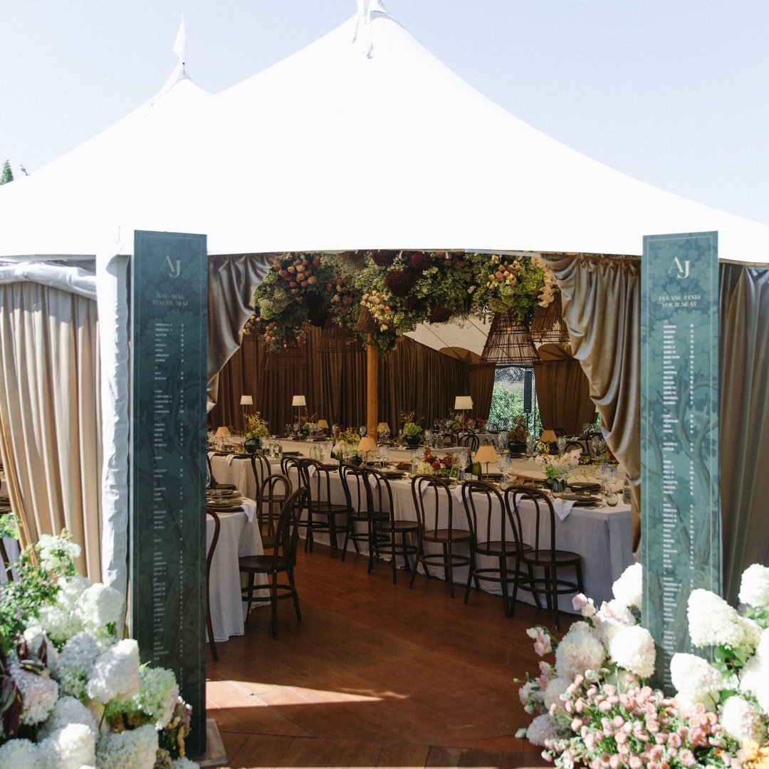 Angela and Justin’s wedding seating plan pillars framing the entrance to the reception at Putiki Estate.