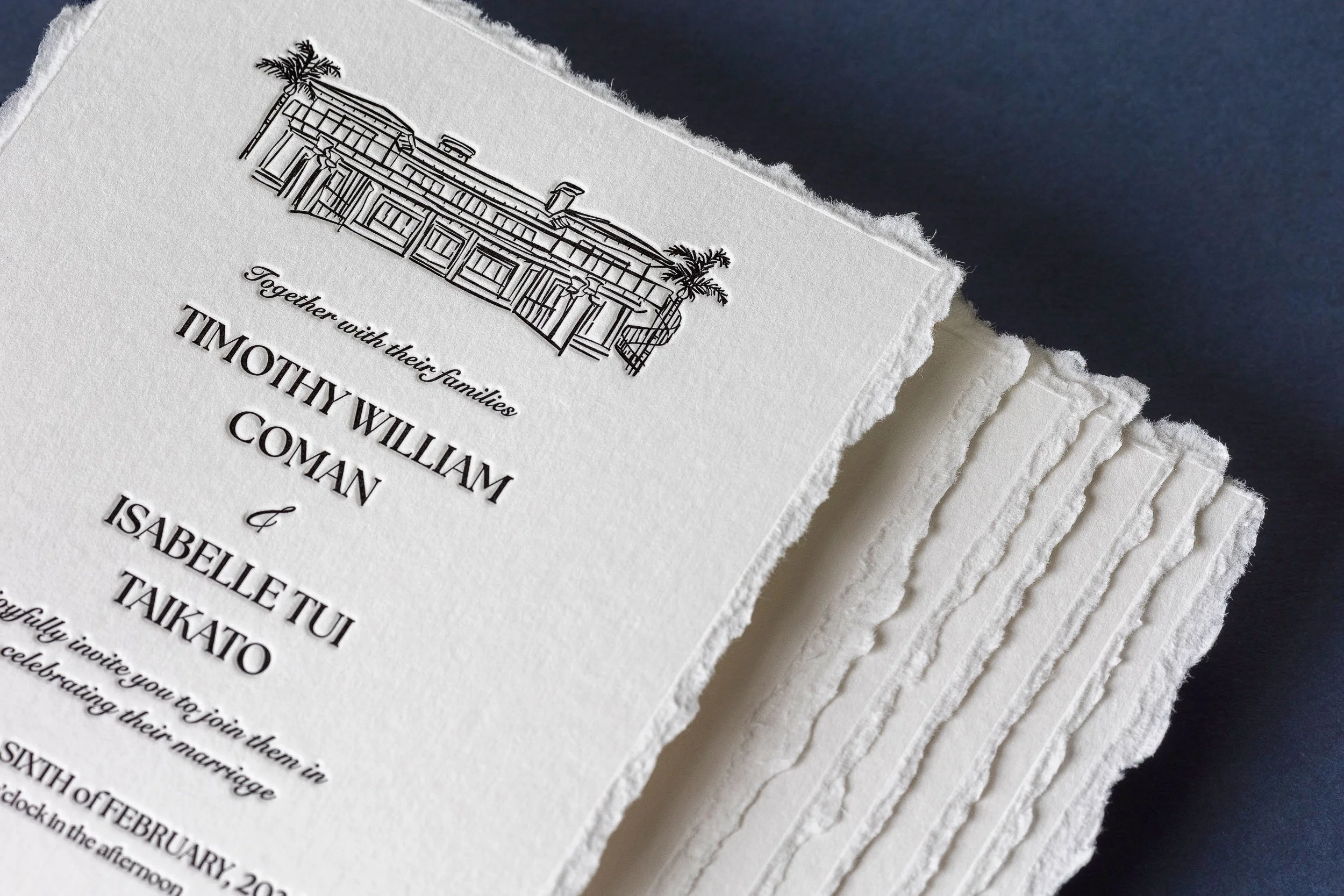 Deckled-edge letterpress wedding invitations featuring an illustration of Ataahua Estate on soft cotton paper.