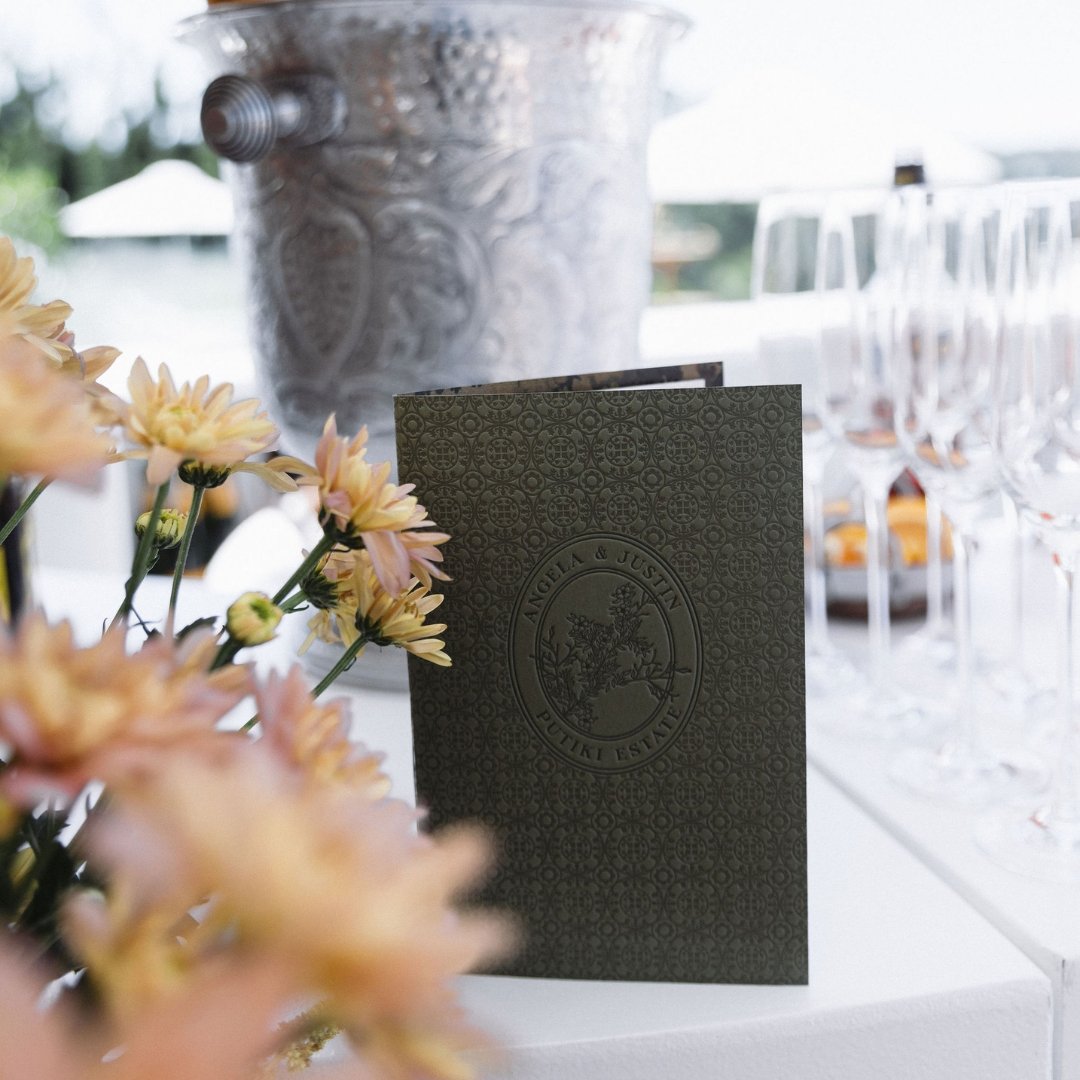 Angela and Justin’s letterpress bar menu at Putiki Estate, featuring the custom wedding crest and tile-inspired pattern.
