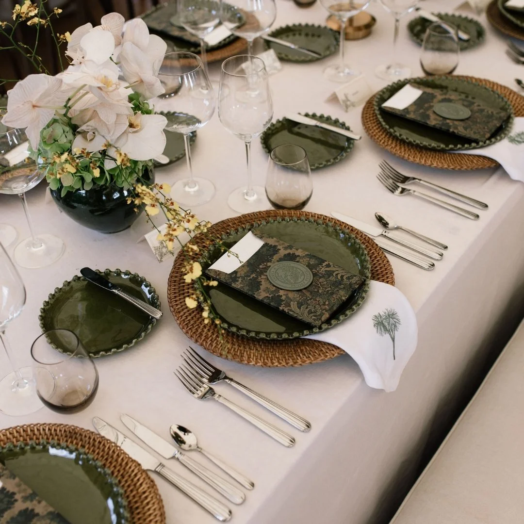 Putiki Estate wedding table setting with tapestry artwork menus and embroidered tī kōuka napkins.
