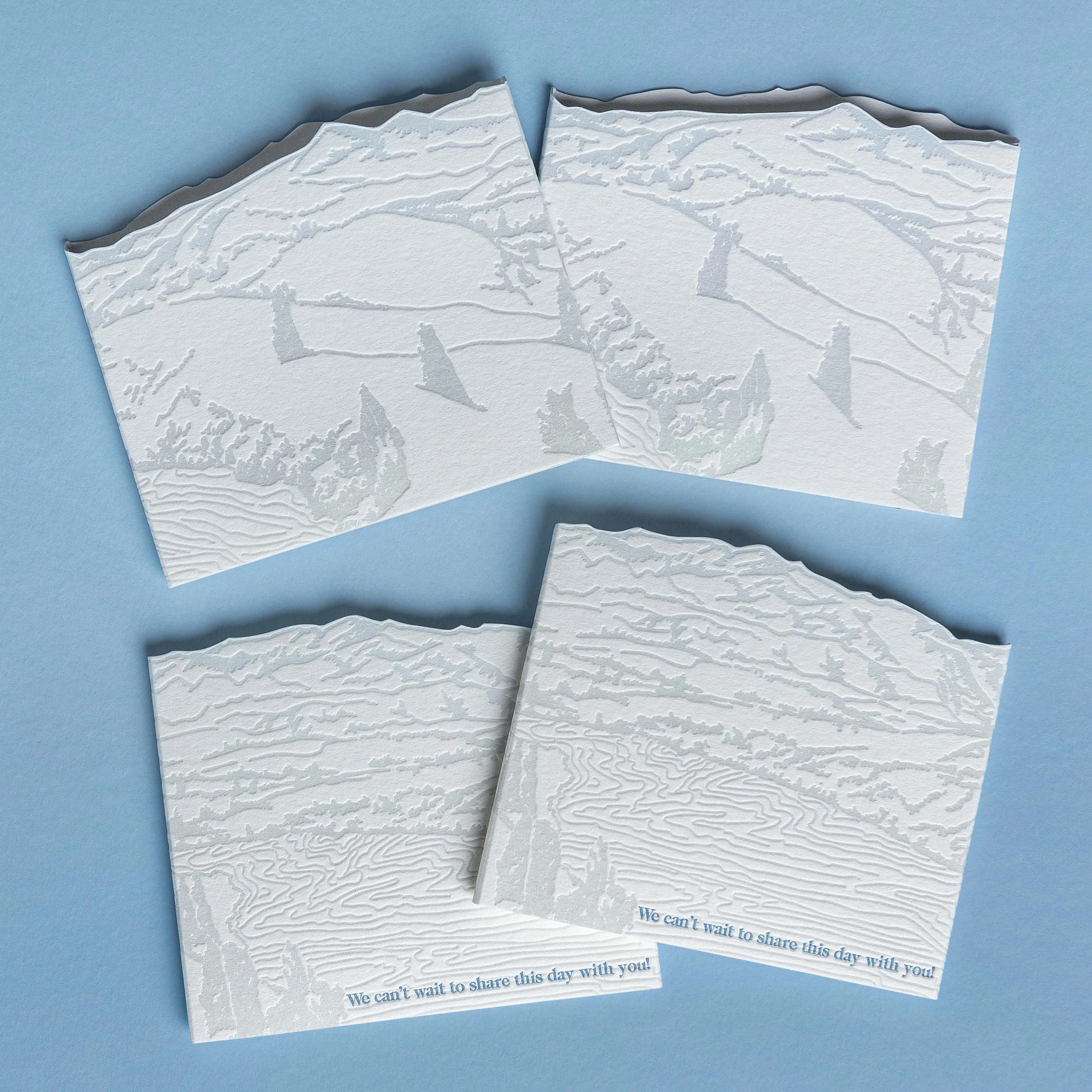 Letterpress invitation wrap featuring a layered landscape illustration inspired by the view from NZ High Country, shown front and back.
