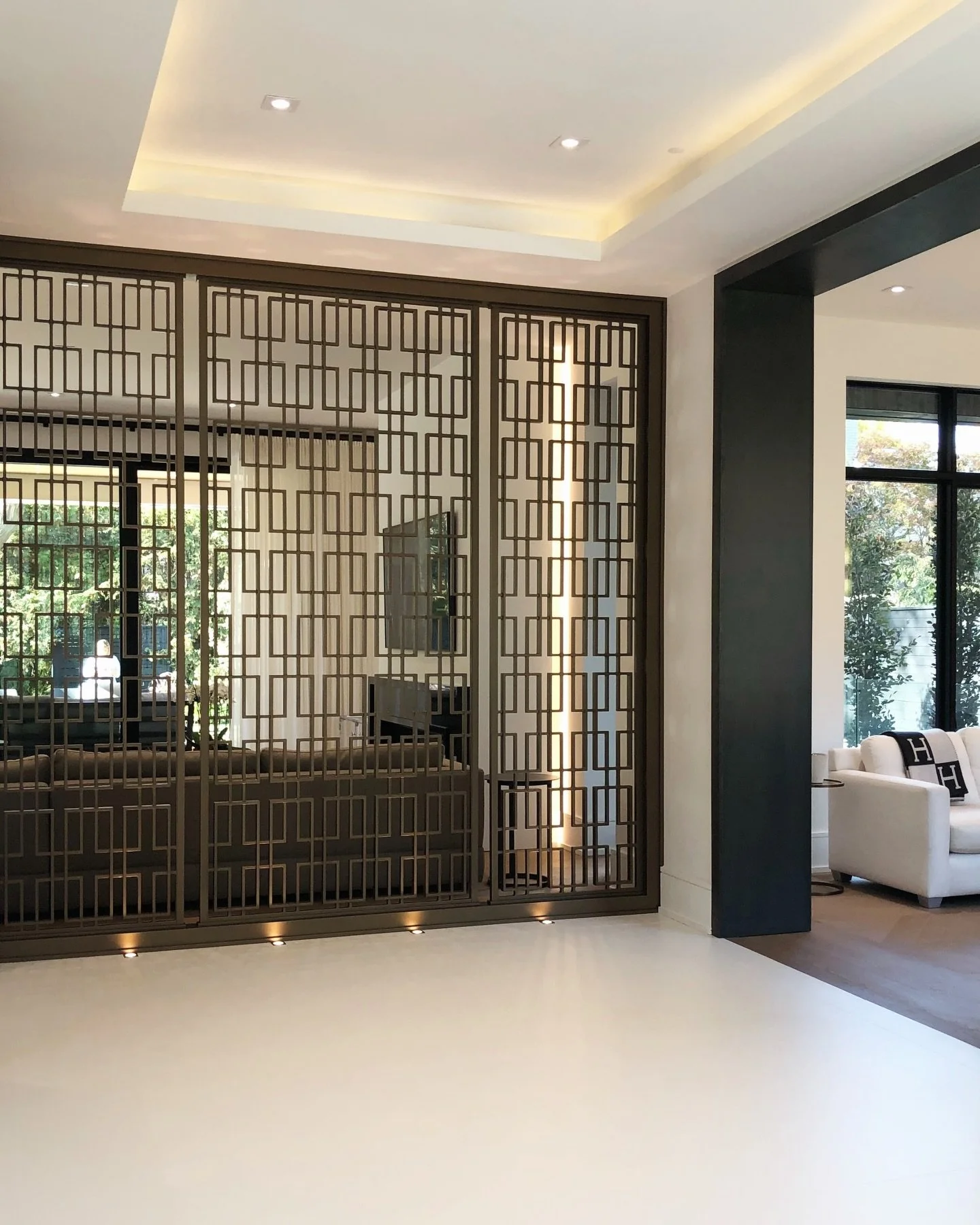 Framed by custom metalwork and gentle light, this space becomes a passage rather than a hallway, intentional, restrained, and quietly expressive of the home&rsquo;s architectural language. 
&bull;
&bull;
&bull;
#LuxuryInteriorDesign #CustomMetalwork 